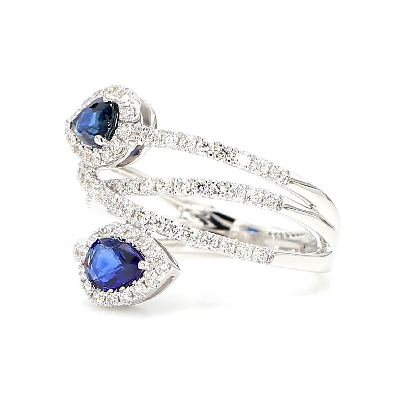 RareGemWorld's beautiful sapphire ring. Mounted in a beautiful 18K White Gold setting with two natural pear cut blue sapphires surrounded by natural round white diamond melee. This ring is guaranteed to impress and enhance your personal