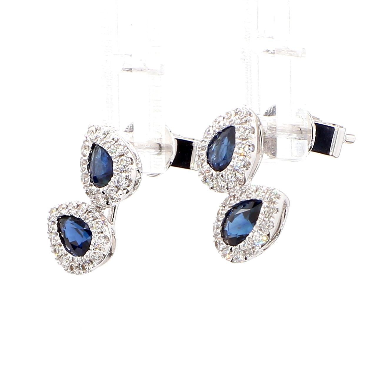 RareGemWorld's beautiful sapphire earrings. Mounted in a beautiful 18K White Gold setting with natural pear cut blue sapphires. The sapphires are surrounded by natural round white diamond melee. These earrings are guaranteed to impress and enhance