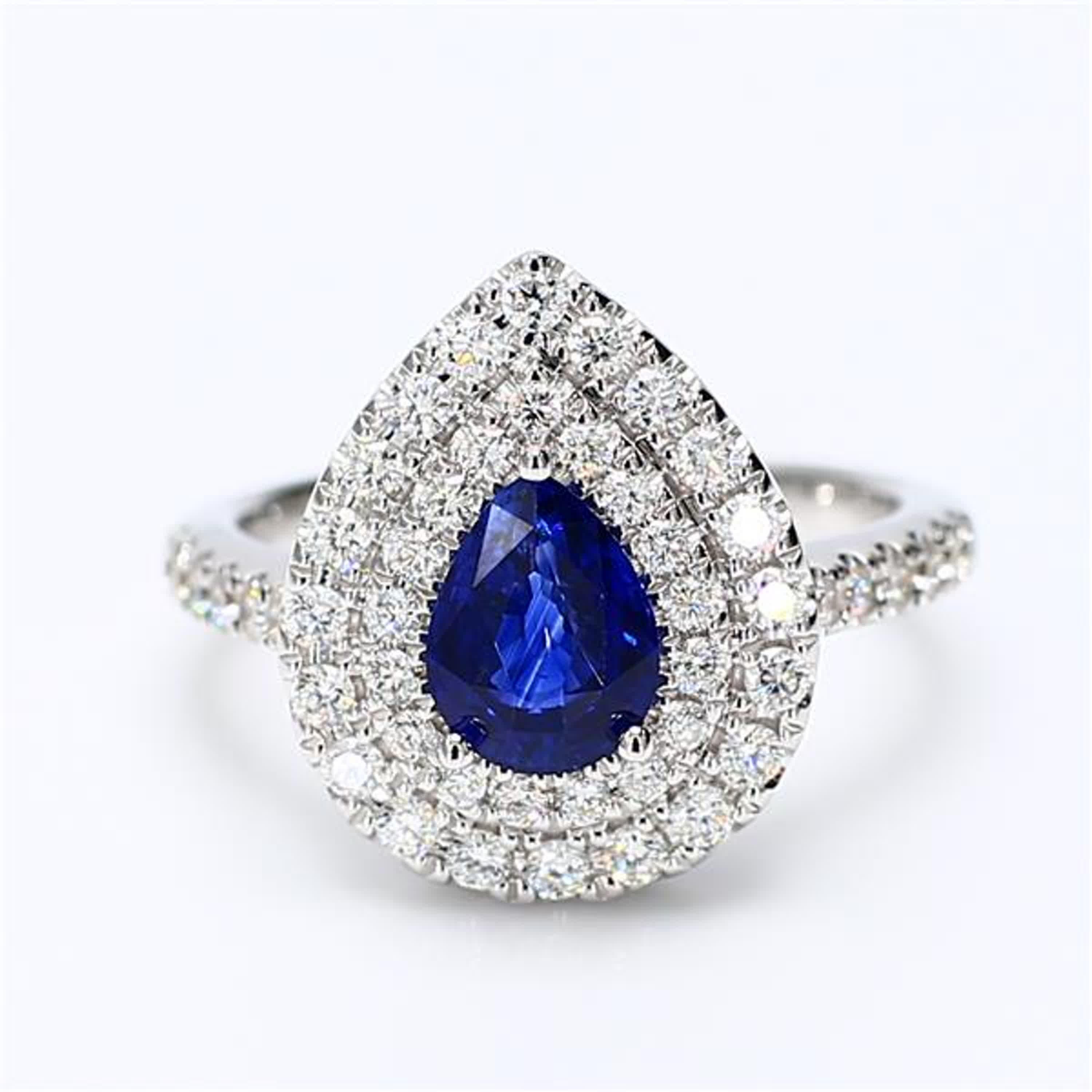 RareGemWorld's classic sapphire ring. Mounted in a beautiful 18K White Gold setting with a natural pear cut blue sapphire. The sapphire is surrounded by natural round white diamond melee. This ring is guaranteed to impress and enhance your personal