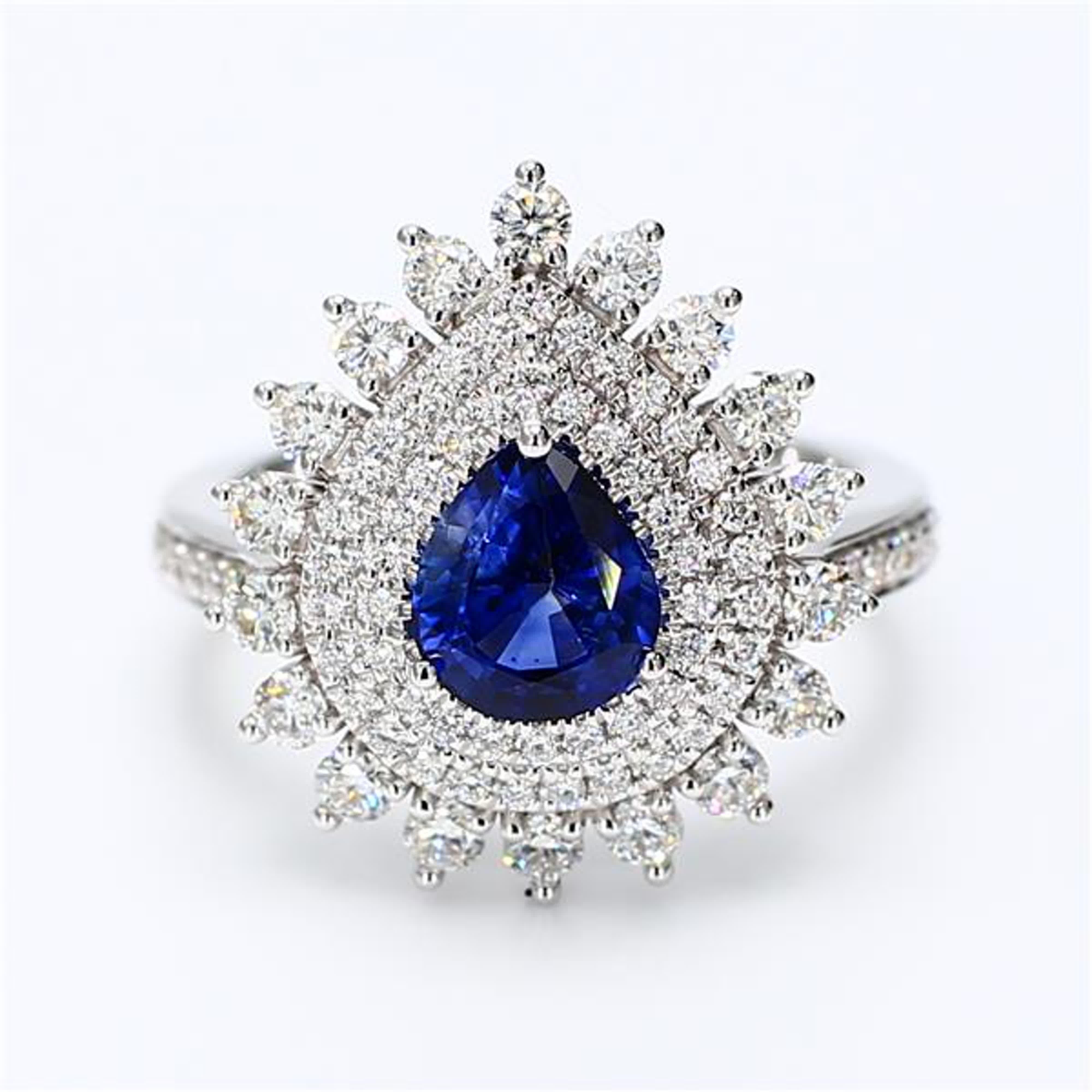 RareGemWorld's classic natural pear cut sapphire ring. Mounted in a beautiful 18K White Gold setting with a natural pear cut blue sapphire. The sapphire is surrounded by natural round white diamond melee. This ring is guaranteed to impress and