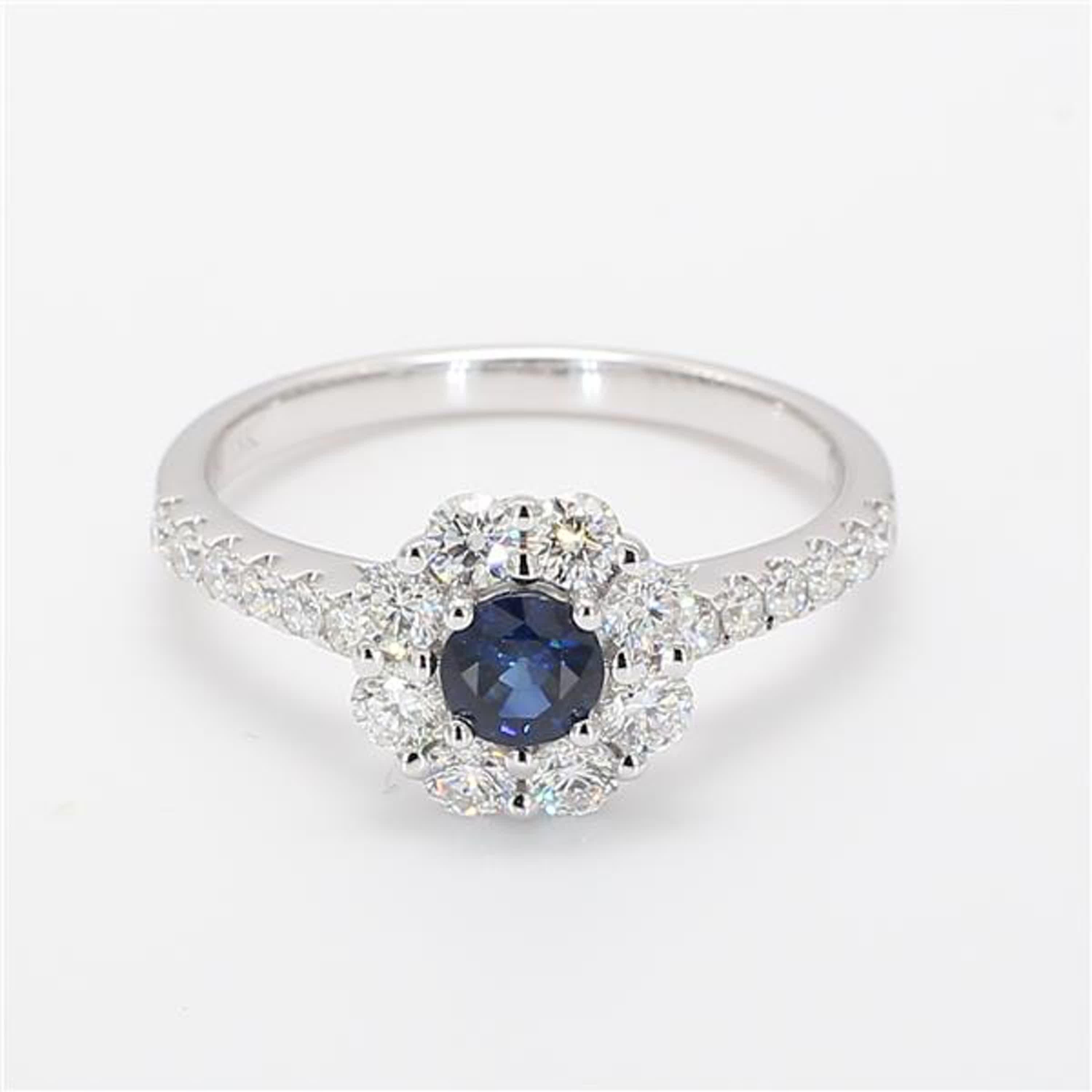 RareGemWorld's classic sapphire ring. Mounted in a beautiful 18K White Gold setting with a natural round cut blue sapphire. The sapphire is surrounded by natural round white diamond melee. This ring is guaranteed to impress and enhance your personal