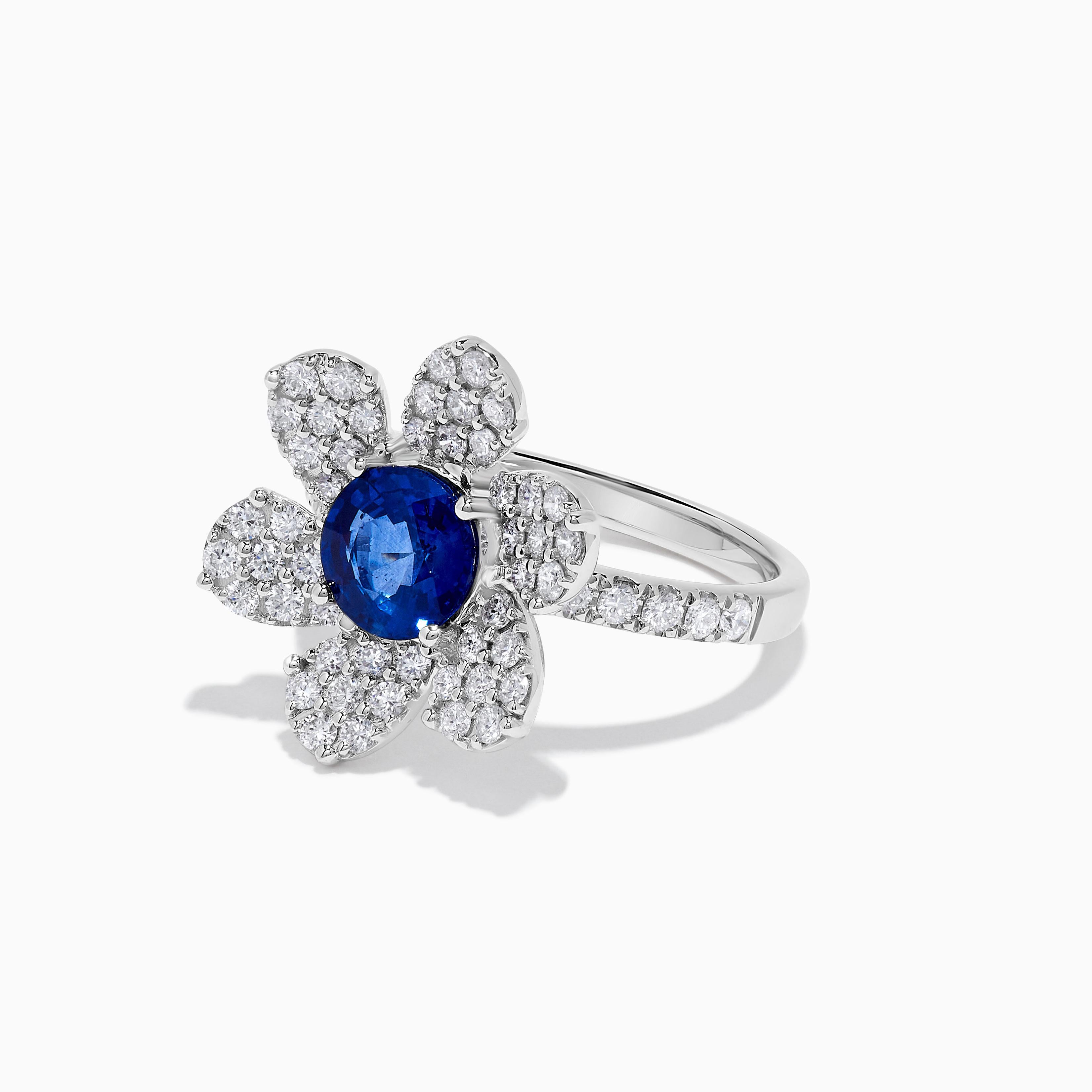 RareGemWorld's classic sapphire ring. Mounted in a beautiful 18K White Gold setting with a natural round cut blue sapphire. The sapphire is surrounded by natural round white diamond melee. This ring is guaranteed to impress and enhance your personal
