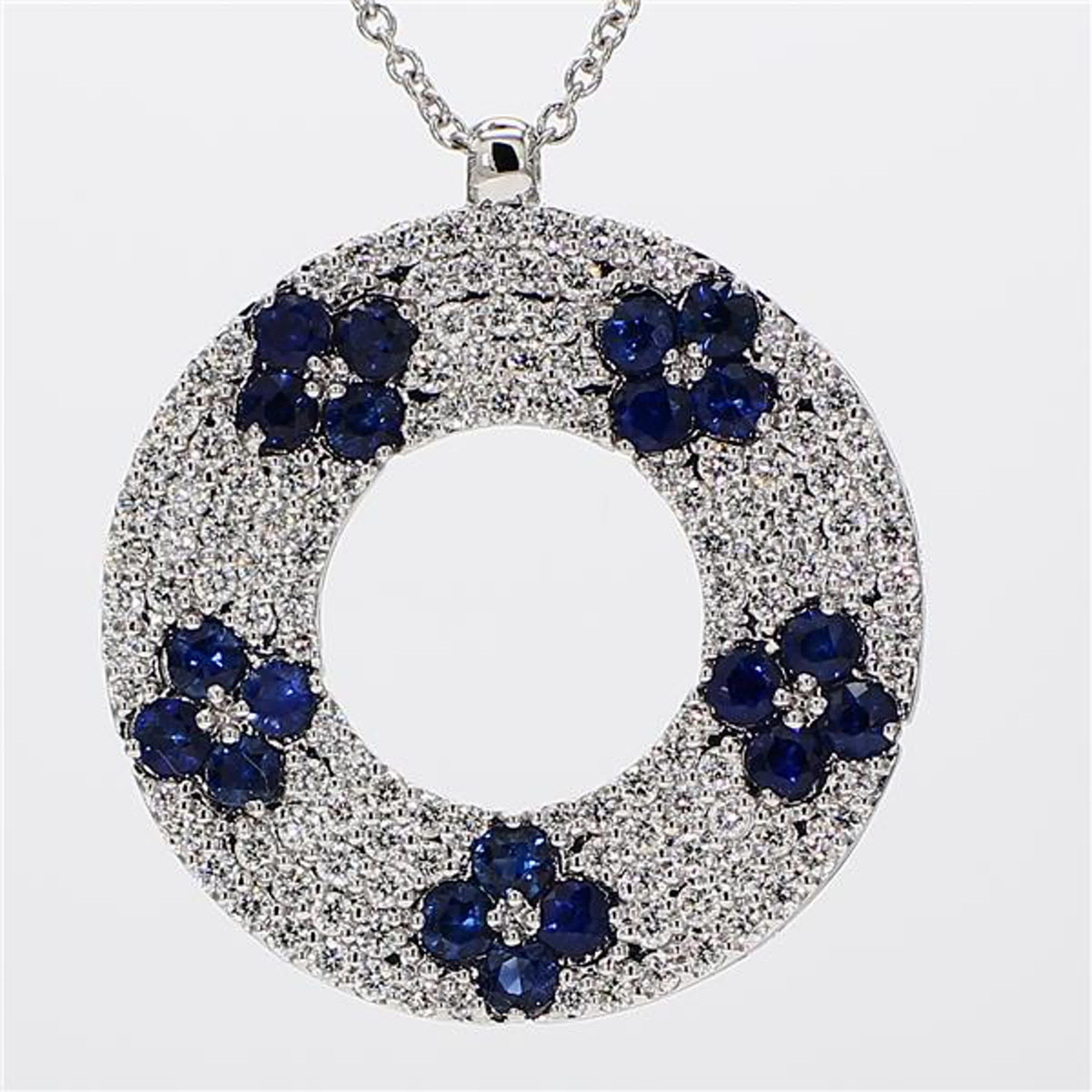 RareGemWorld's classic sapphire pendant. Mounted in a beautiful 18K White Gold setting with a natural round cut blue sapphires complimented by natural round cut white diamond melee. This pendant is guaranteed to impress and enhance your personal