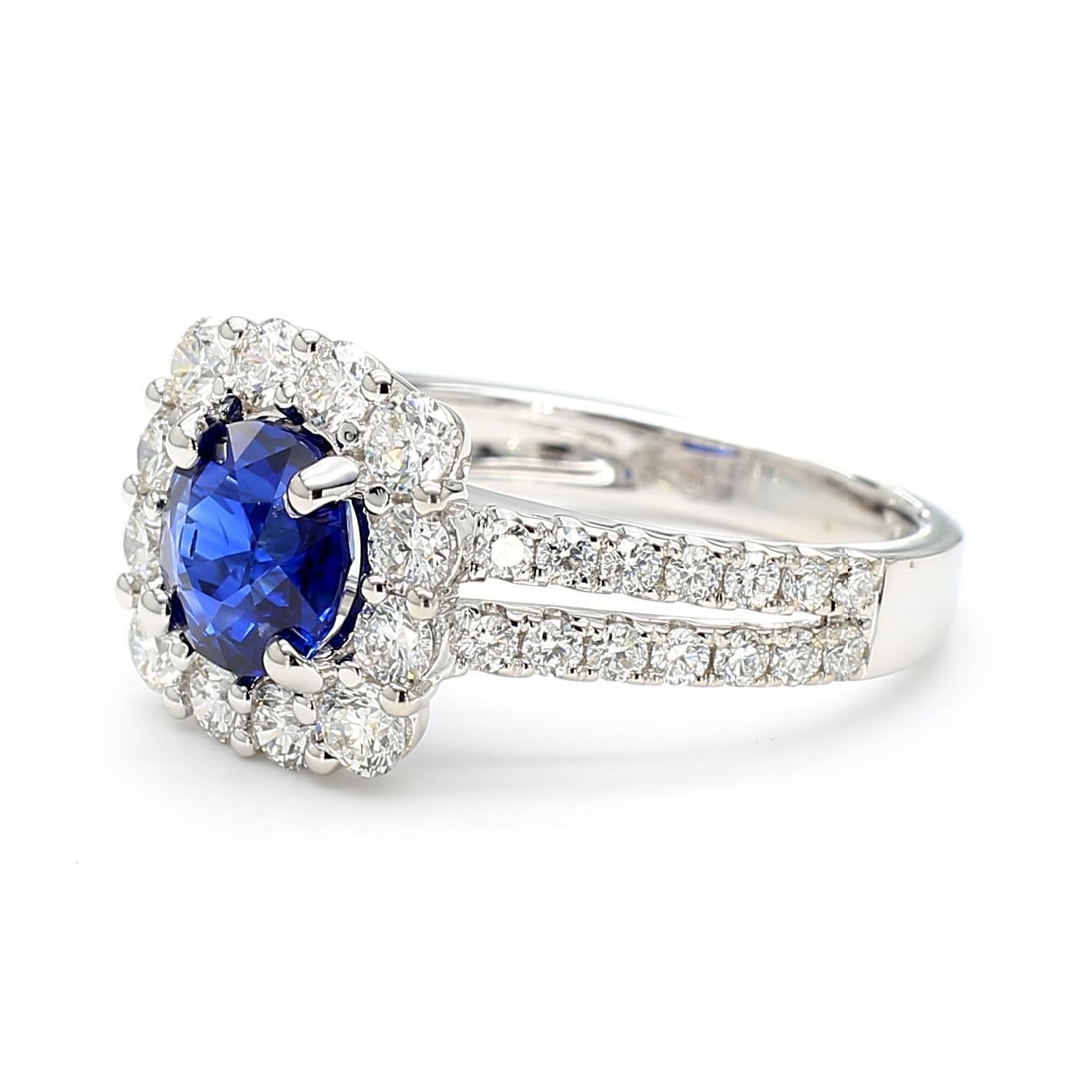 RareGemWorld's beautiful sapphire ring. Mounted in a beautiful 18K White Gold setting with a natural round cut blue sapphire. The sapphire is surrounded by natural round white diamond melee. This ring is guaranteed to impress and enhance your