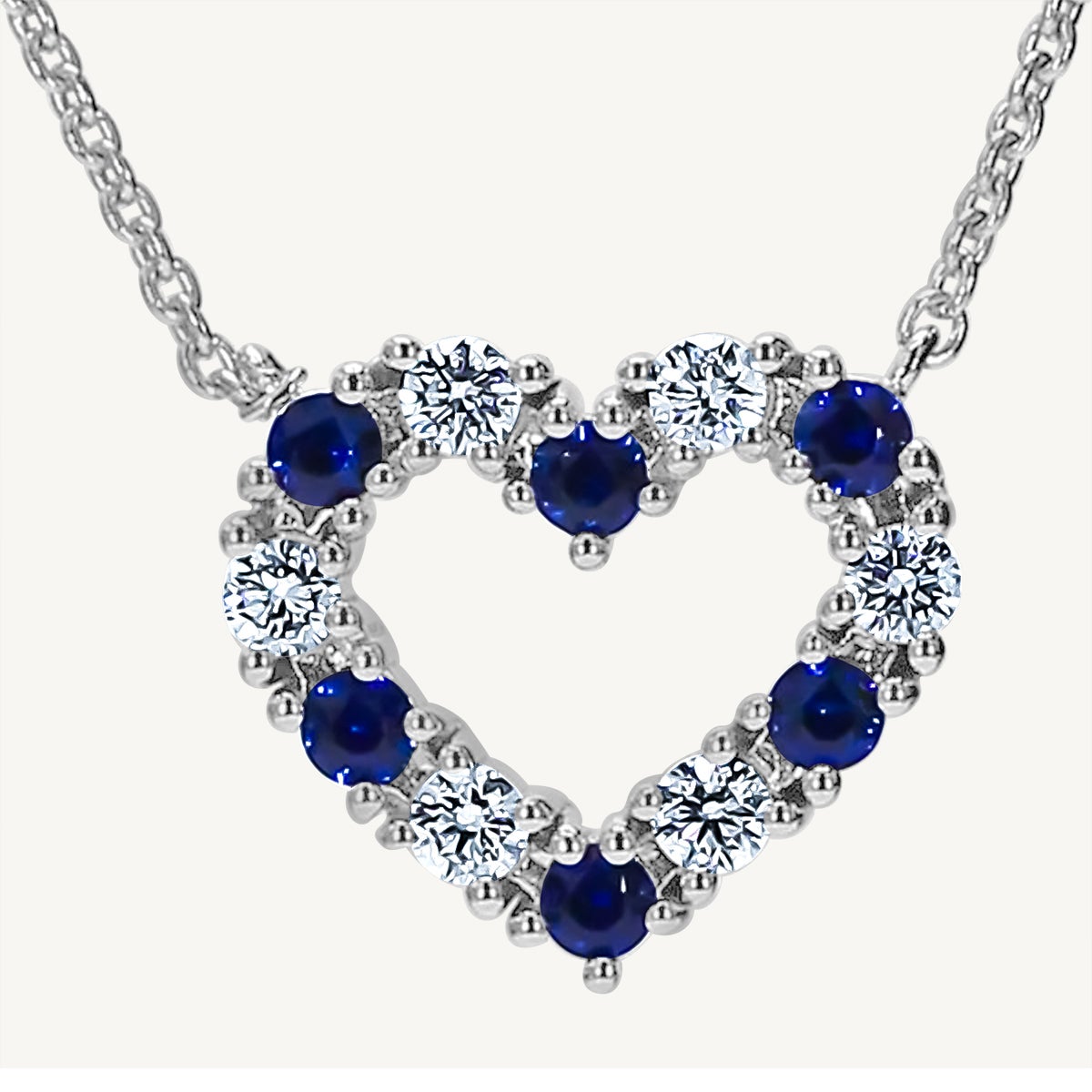 Natural Blue Round Sapphire and White Diamond .53 Carat TW White Gold Pendant