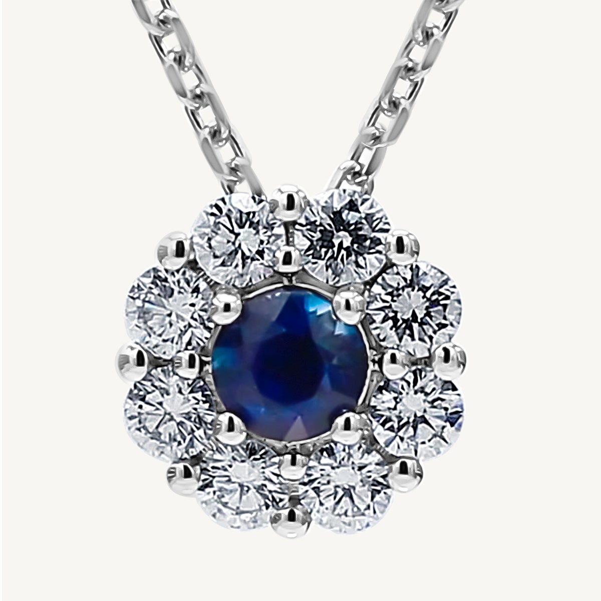 Natural Blue Round Sapphire and White Diamond .88 Carat TW White Gold Pendant For Sale