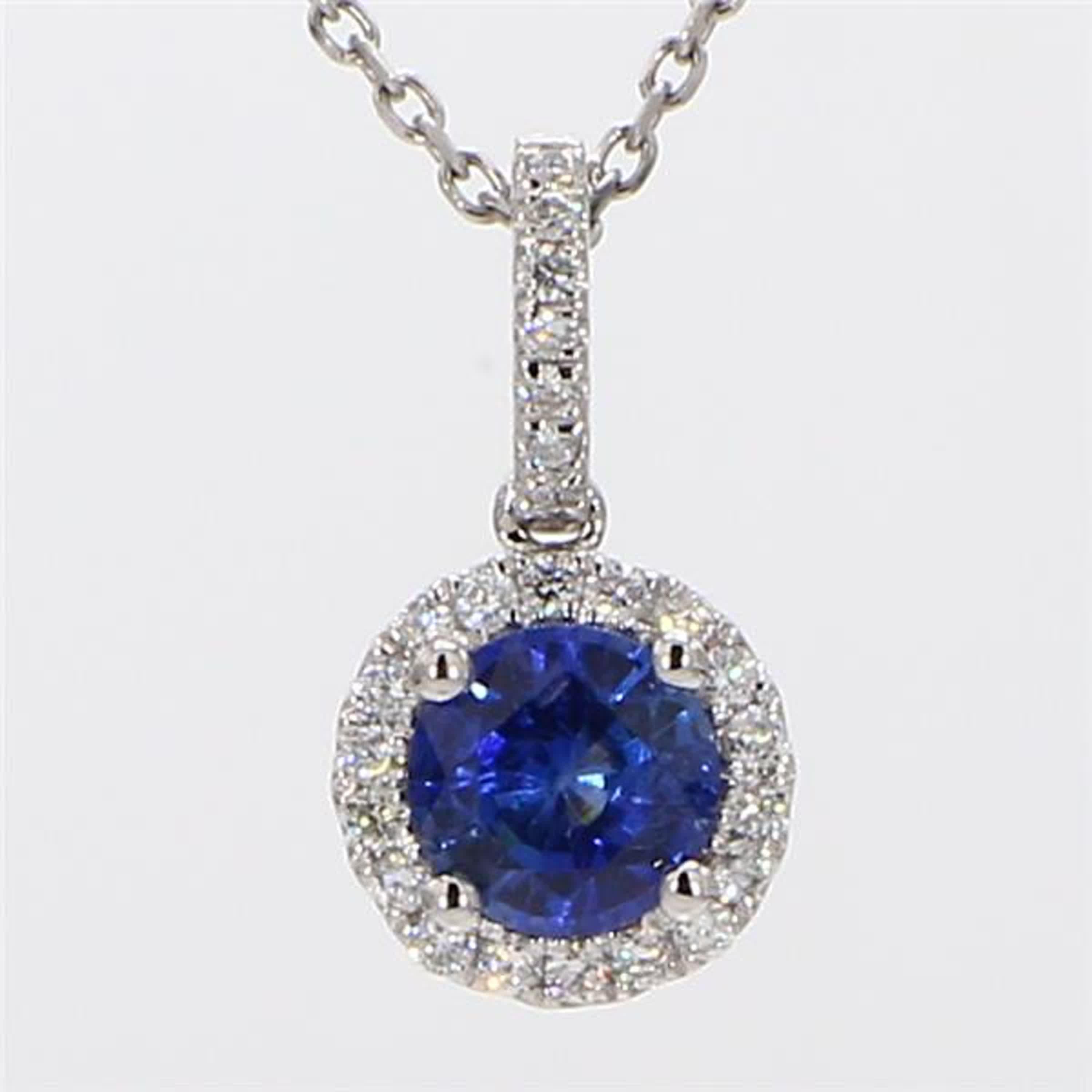 RareGemWorld's classic sapphire pendant. Mounted in a beautiful 14K White Gold setting with a natural round cut blue sapphire. The sapphire is surrounded by natural round white diamond melee in a beautiful single halo as well as throughout the