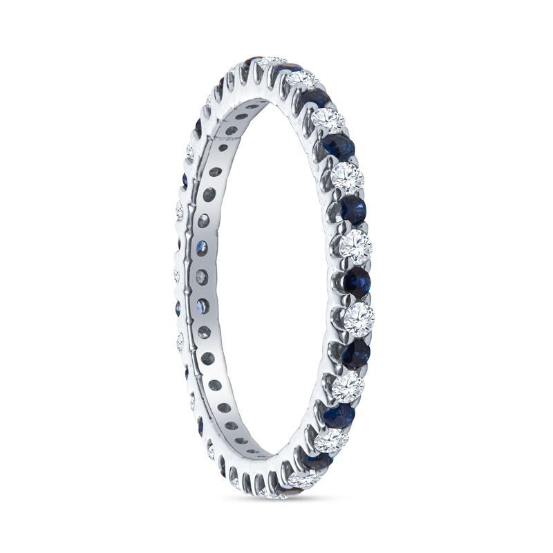 This band features 0.20 carat total weight in blue sapphire alternating with 0.30 carat total weight in diamonds set in 14 karat white gold. Wear alone, with your engagement ring, or layer with your other favorite rings. It is a size 5.75. 
