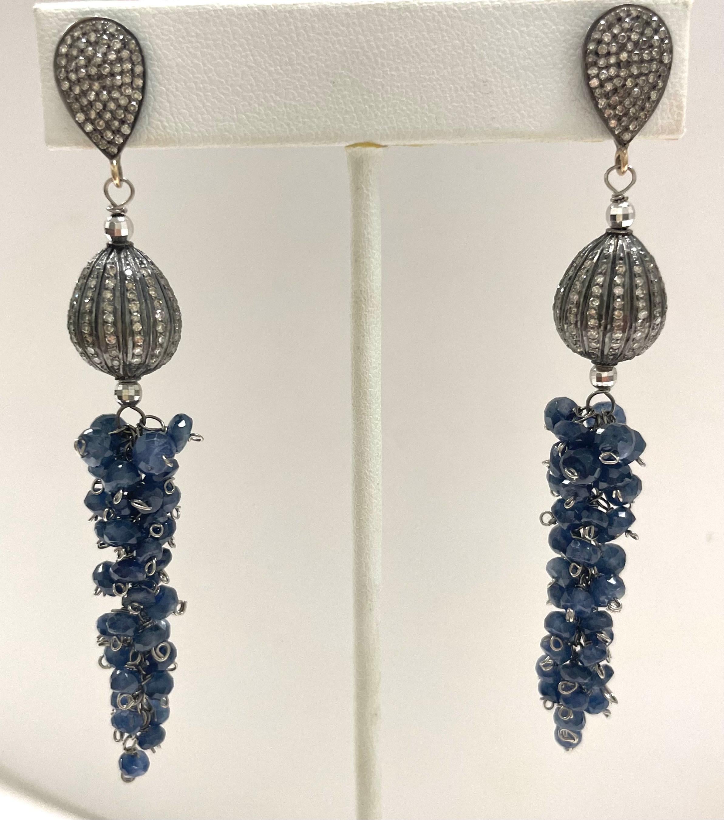 Description
Luscious and whimsical cluster of natural untreated blue sapphires dangling from pear shape stud earrings enhanced with pave diamonds.
Item # E3291
Check out matching necklace (see photo), Item # N3383

Materials and Weight
Blue