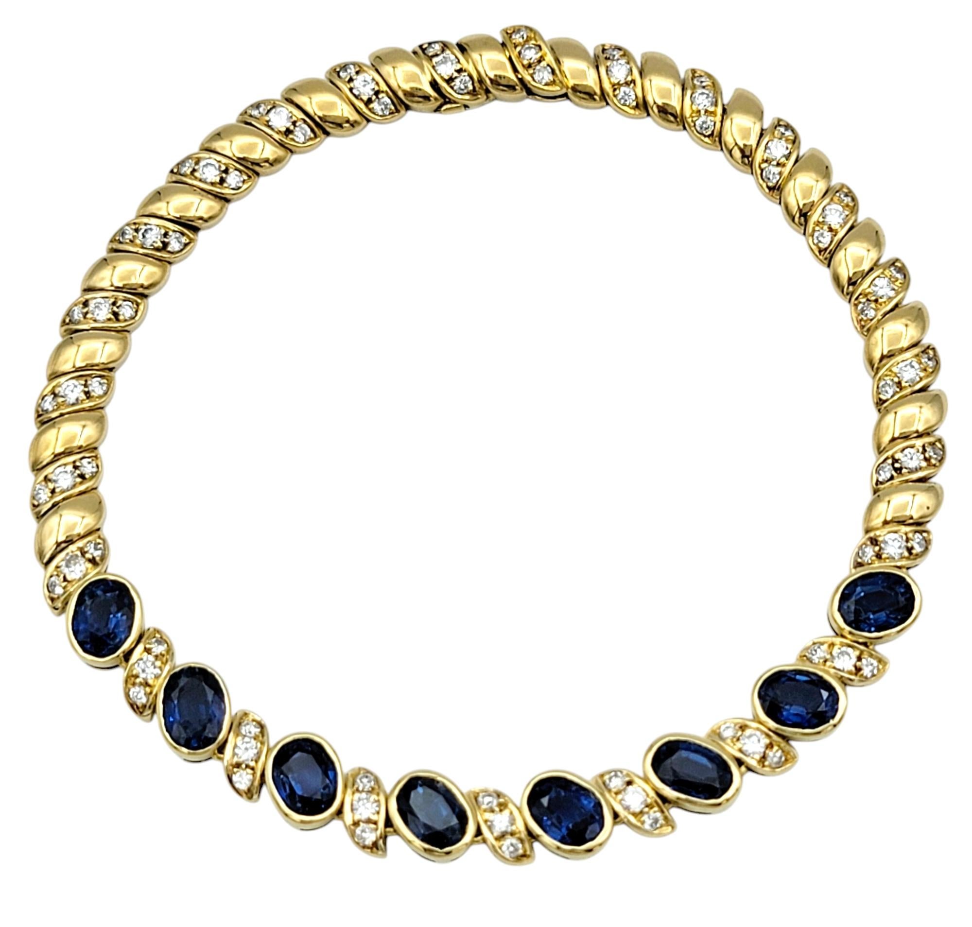 Embrace timeless elegance with this exquisite natural sapphire and diamond line bracelet crafted in rich 18 karat yellow gold. Each sapphire, a deep, velvety blue, is bezel-set to showcase its brilliant color and captivating depth. These vibrant