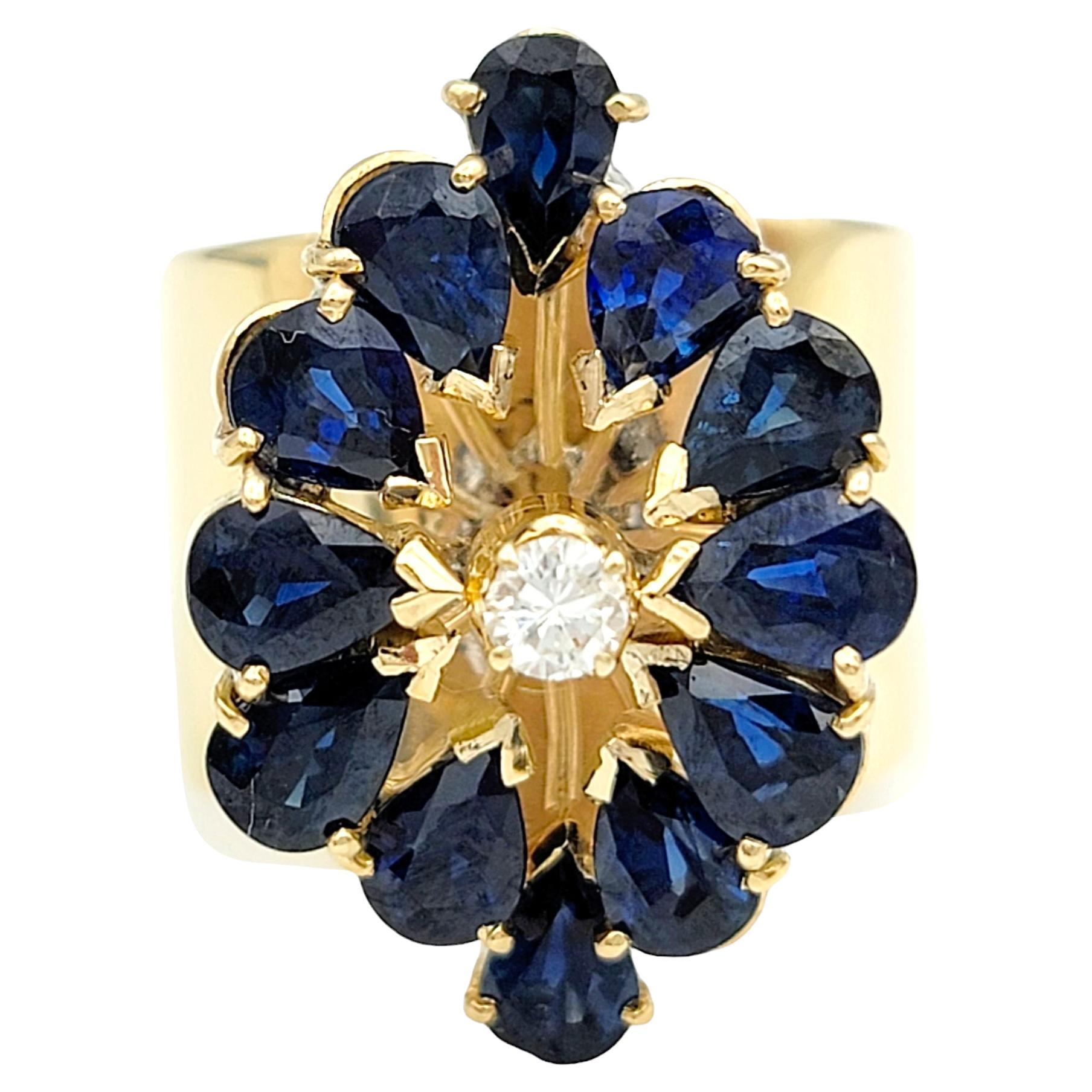 Misura dell'anello: 6

Lasciati sedurre dalla bellezza del nostro splendido anello cocktail con zaffiro blu e diamante impilato, incastonato in un lussuoso oro giallo da 14 carati.  Questo splendido anello mette in mostra vibranti zaffiri blu taglio
