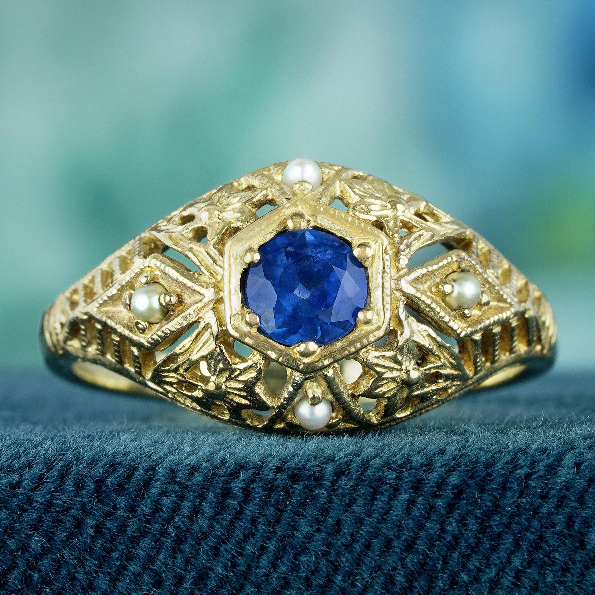 Expertly crafted from delicate filigree yellow gold, this captivating vintage design encircles the round blue sapphire at its center with timeless elegance. Intricate openwork detailing enhances the ring, infusing it with a touch of vintage glamour.