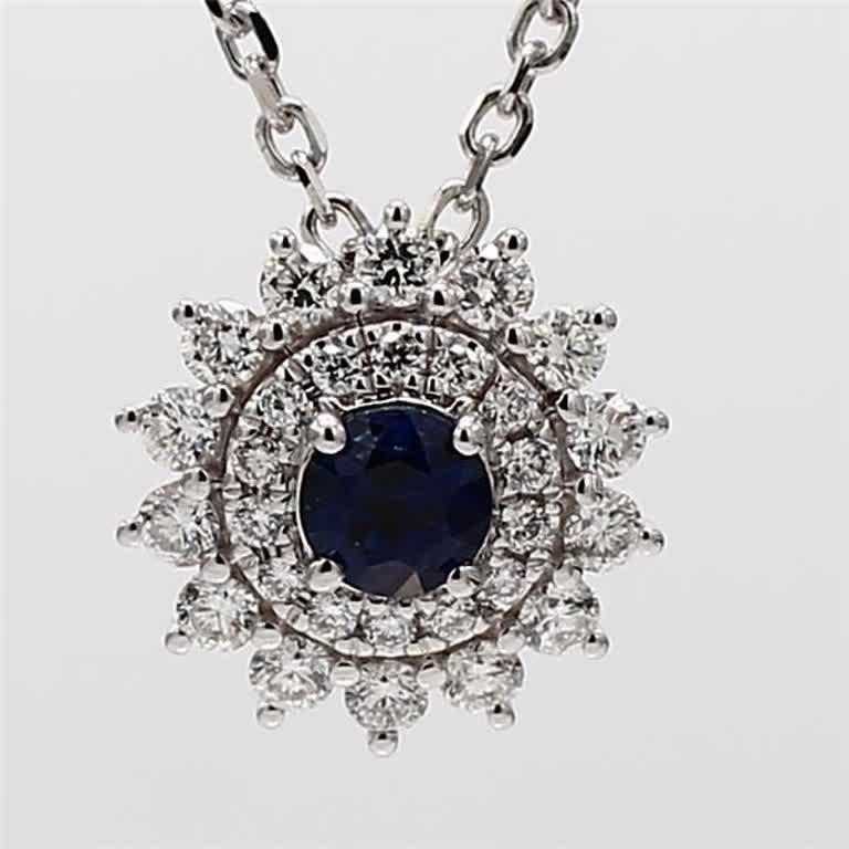 RareGemWorld's classic sapphire pendant. Mounted in a beautiful 14K White Gold setting with a natural round cut blue sapphire. The sapphire is surrounded by natural round white diamond melee in a beautiful flower shape. This pendant is guaranteed to