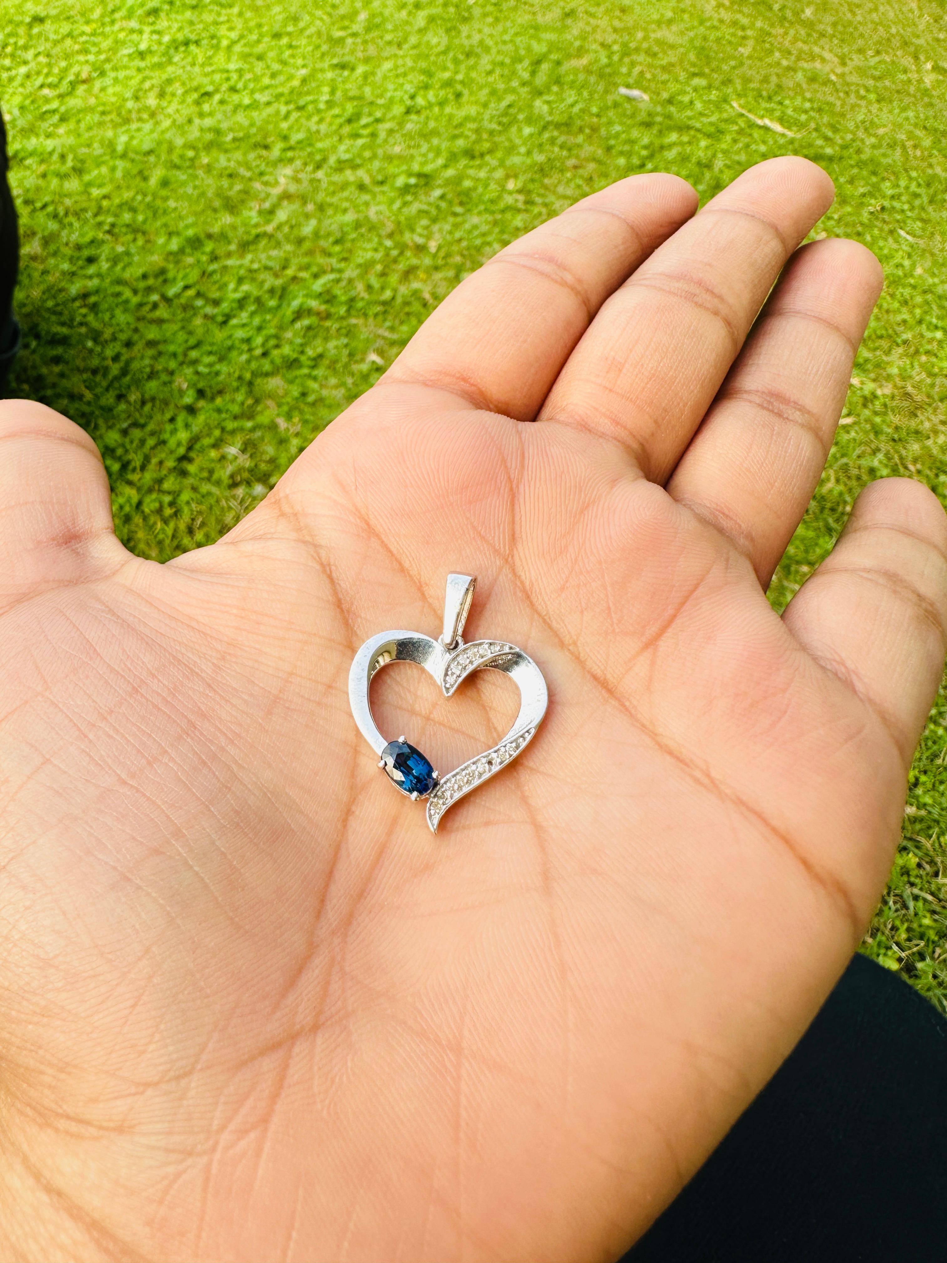 Natural Blue Sapphire Diamond Heart Pendant in sterling silver studded with oval cut blue sapphire band round cut diamonds. This stunning piece of jewelry instantly elevates a casual look or dressy outfit.
Blue Sapphire brings energy, calmness and