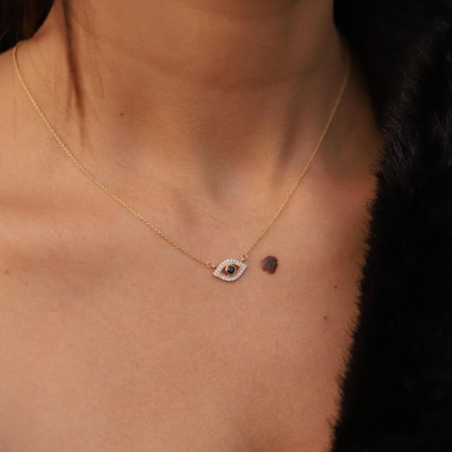 Natural Blue Sapphire Diamond Evil Eye Pendant Necklace in 14K Gold studded with round cut blue sapphire and round cut diamonds. This stunning piece of jewelry instantly elevates a casual look or dressy outfit. 
Sapphire stimulate concentration and