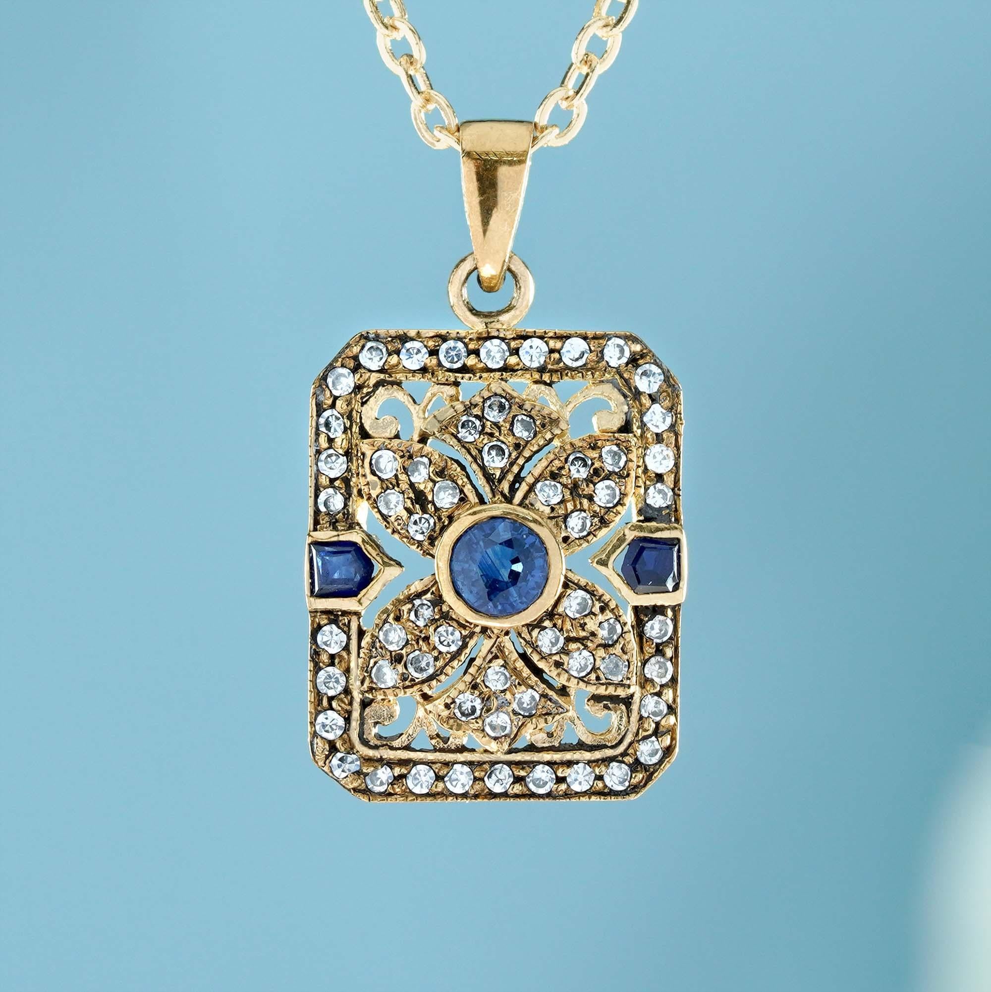 The pendant features a oval-shaped sapphire gemstone in the center, set in a bezel setting. The sapphire has a deep, rich blue color, and appears to be faceted, which means it’s been cut and polished to maximize its sparkle and brilliance. The