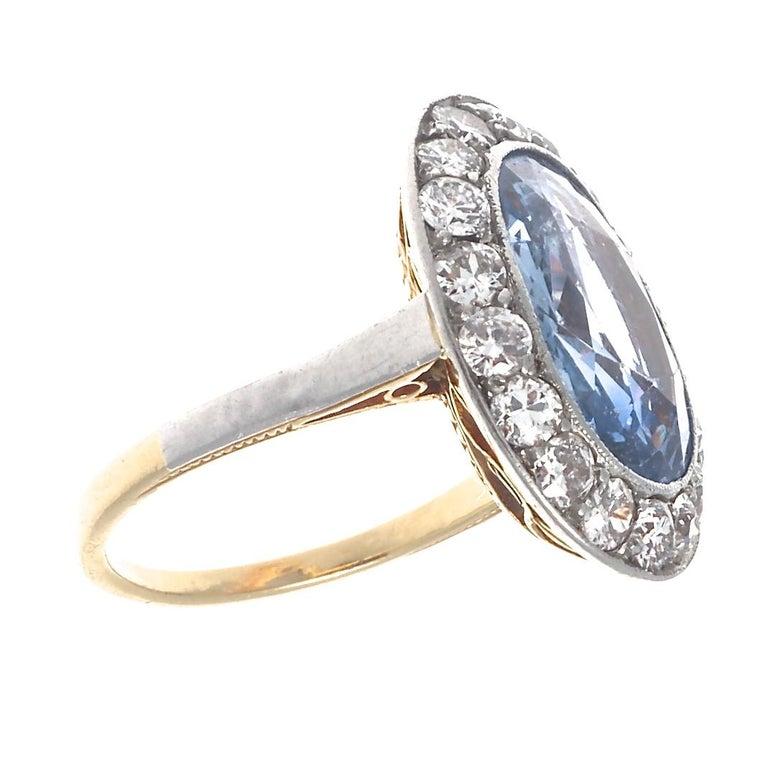 Featuring a GIA certified Ceylon sapphire that weighs approximately 4.75 carats, this natural blue sapphire engagement ring is a timelessly stunning statement ring from the Edwardian era. Set in 18k yellow gold and accented with 18 old European cut