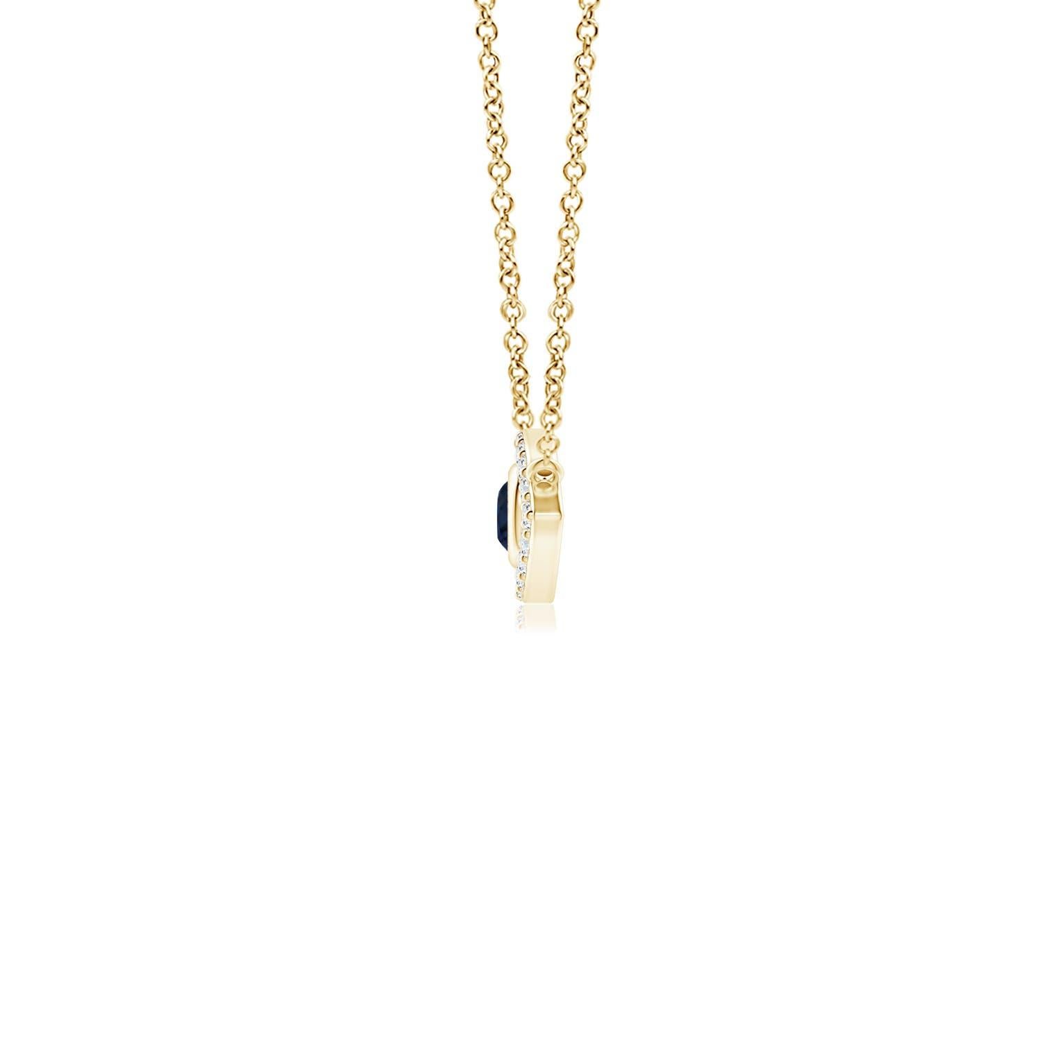 Hanging gracefully from a shiny metal bale is a diamond studded frame with a round sapphire bezel set at the center. The sparkling diamonds create a compelling contrast against the deep blue sapphire. Crafted in 18k yellow gold, this sapphire evil