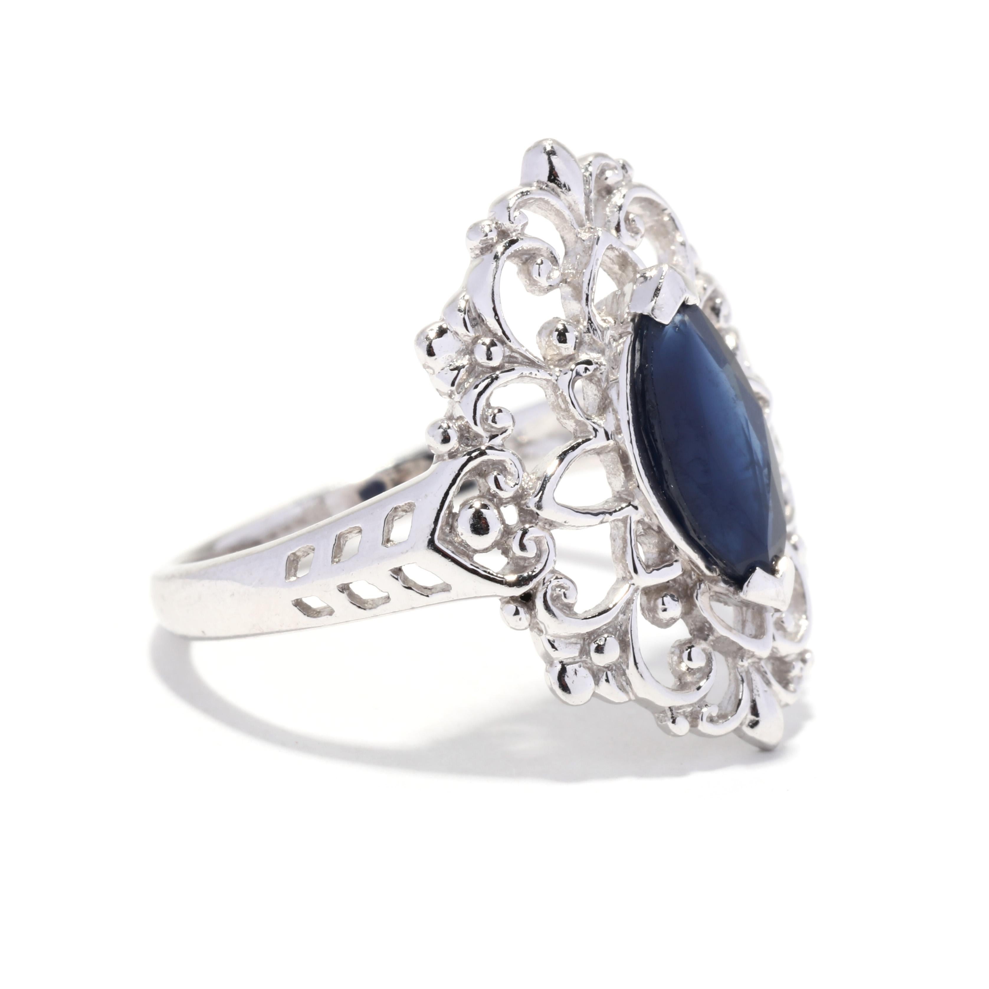A vintage platinum natural blue sapphire filigree navette ring. This statement ring features a prong set, marquise cut sapphire weighing approximately 1.40 carat surrounded by a floral filigree design and with a tapered band.

Stones:
- sapphire, 1