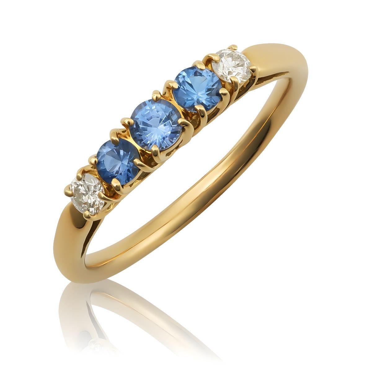 Discover the refined elegance of this 18K yellow gold ring, featuring natural blue sapphires accented by sparkling diamonds. The vibrant blue hue of the sapphires, complemented by brilliant diamonds, creates a captivating and sophisticated piece