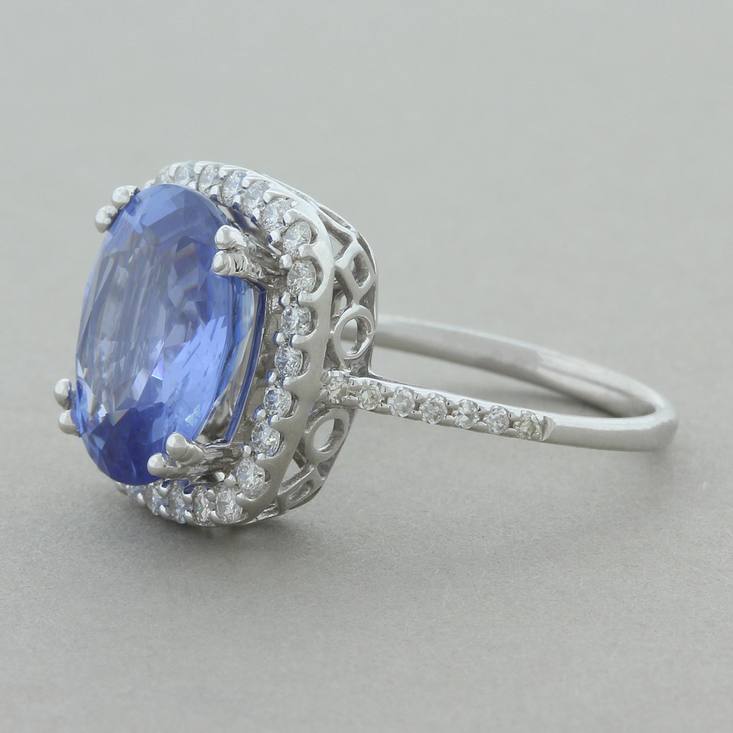 This ring features a natural 4.33 carat gem blue sapphire. The sapphire is certified as being unheated and untreated, less than 5% of stones mined stay untreated. It is haloed by round brilliant cut diamonds which also run along the shoulders on the