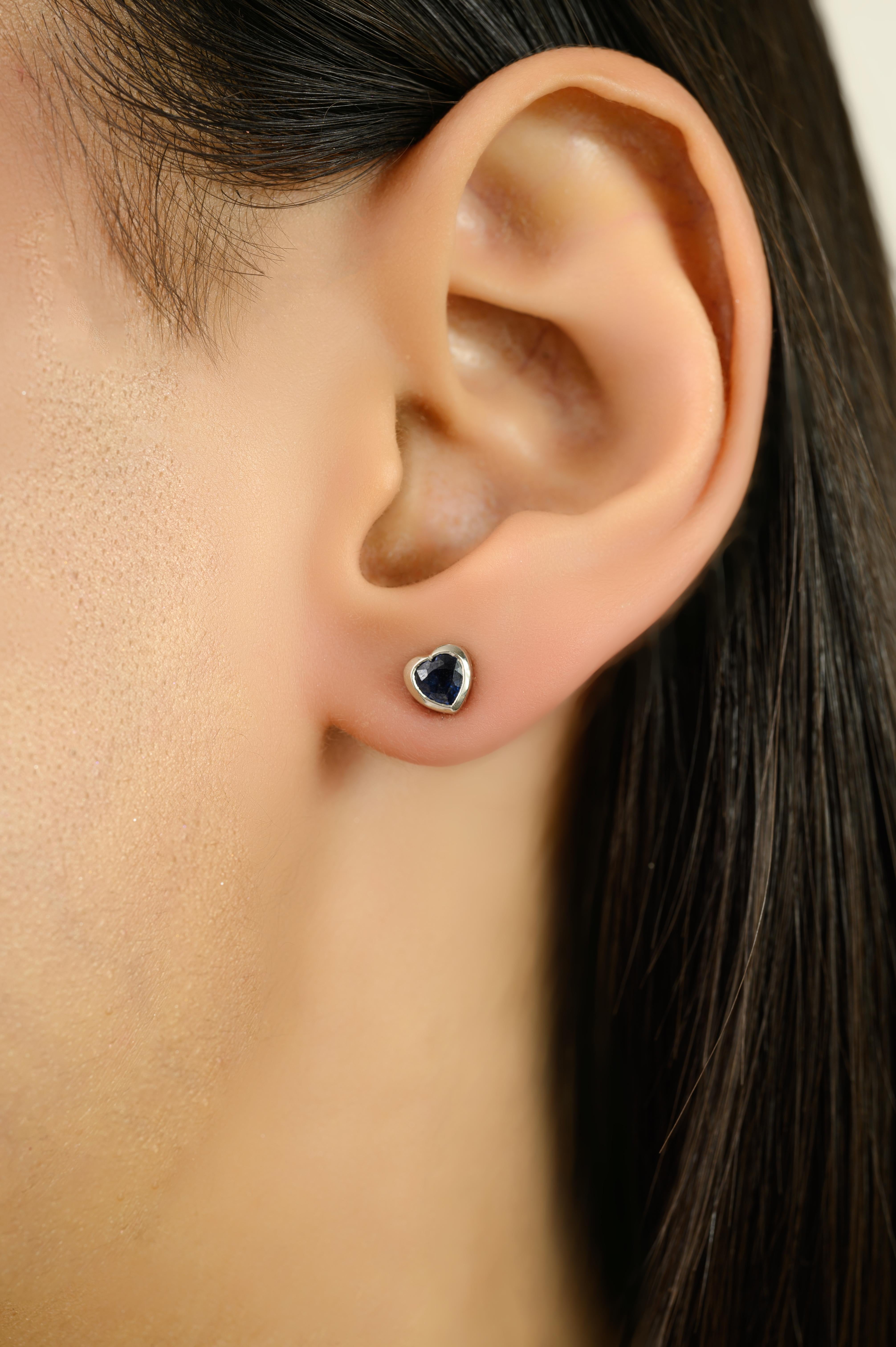 Celebrate love and elegance with these stunning heart blue sapphire stud earrings, crafted in luxurious 14K white gold. Each earring features a rich, deep-blue heart-shaped sapphire, securely bezel-set for a sleek and modern look. The timeless heart