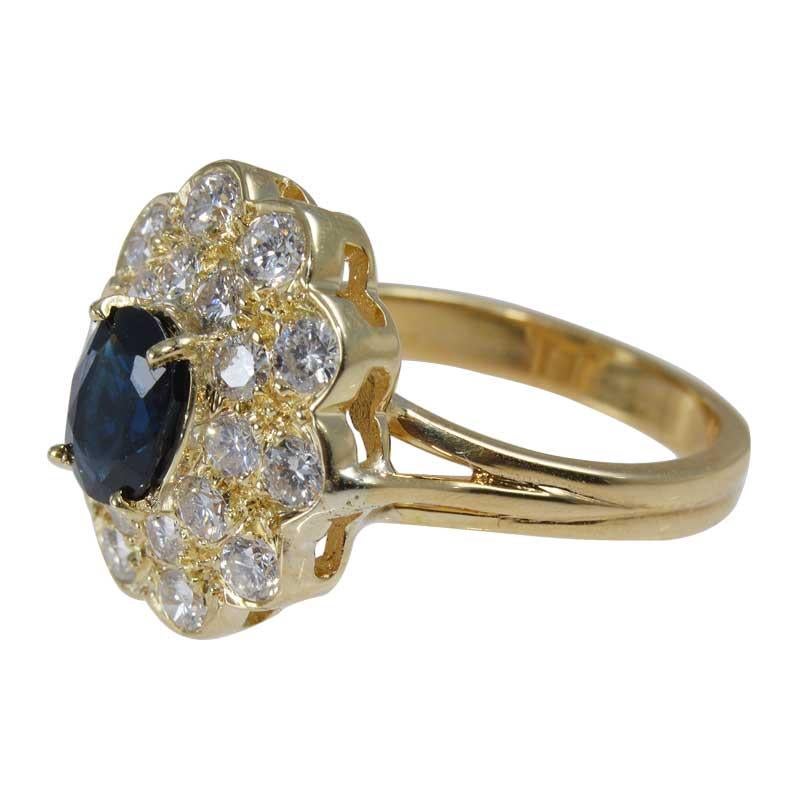 Contemporary Natural Blue Sapphire in a Double Diamond Halo Set in 18Kt Yellow Gold Ring For Sale