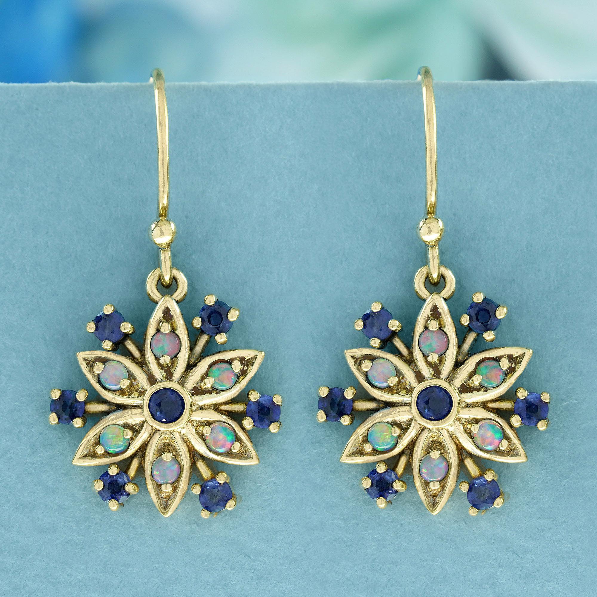 Crafted from luminous yellow gold, these vintage-style earrings boast a Floral Cluster Drop design. Each earring showcases a single floral cluster composed of round Blue Sapphires and Opals set in prongs, adorned with intricate floral openwork