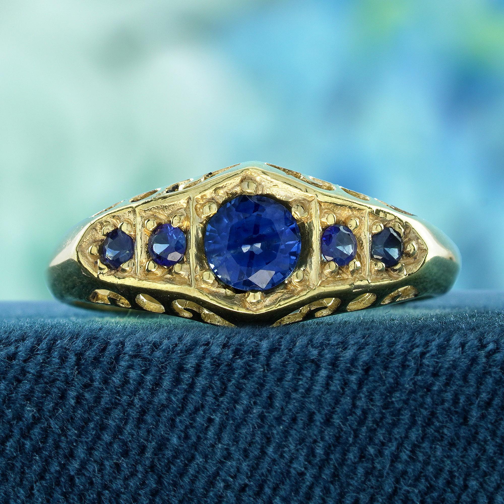 Indulge in the timeless elegance of this stunning vintage-inspired Five Stone ring. Featuring natural blue sapphires, intricate openwork detailing, and yellow gold band, this piece exudes sophistication and classic beauty. The shared prong setting
