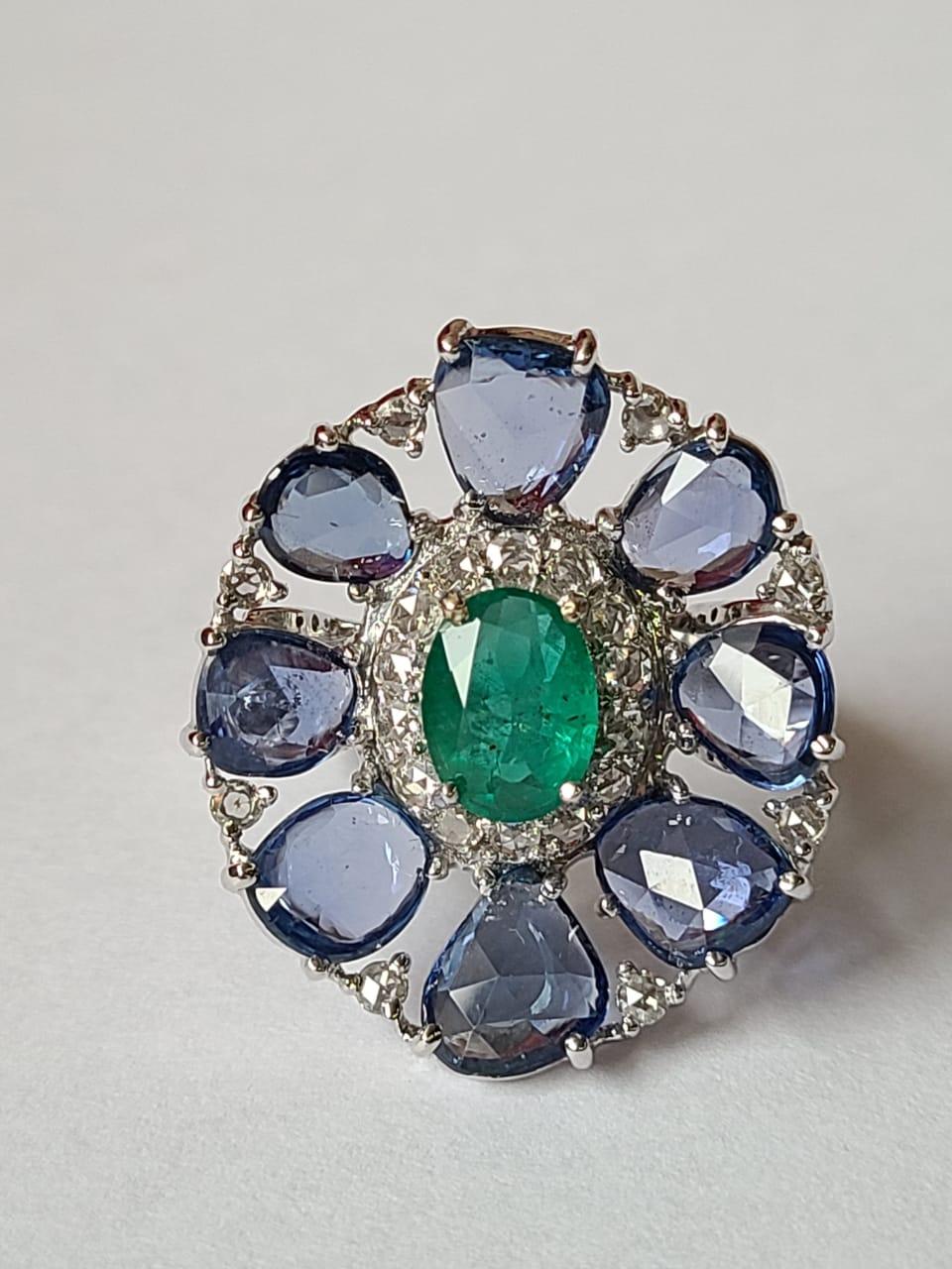 A very beautiful Blue Sapphires & Emerald Cocktail Ring set in 18K White Gold & Diamonds. The weight of the Blue Sapphires Rose Cuts is 6.65 carats. The Blue Sapphires are of Ceylon (Sri Lankan) origin. The weight of the Emerald is 1.32 carats. The