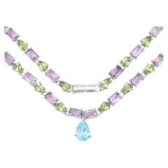 Collier d'éternité en topaze bleue, améthyste et péridot 32 carats en argent