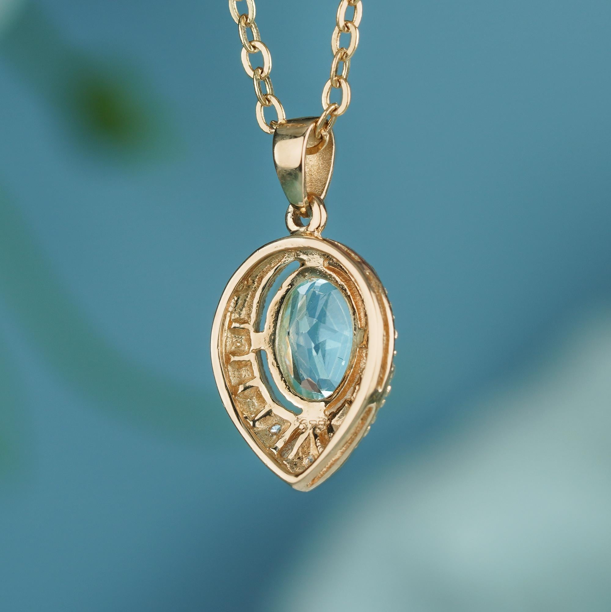 Oval Cut Natural Blue Topaz and Diamond Vintage Style Pendant in solid 9K Yellow Gold For Sale