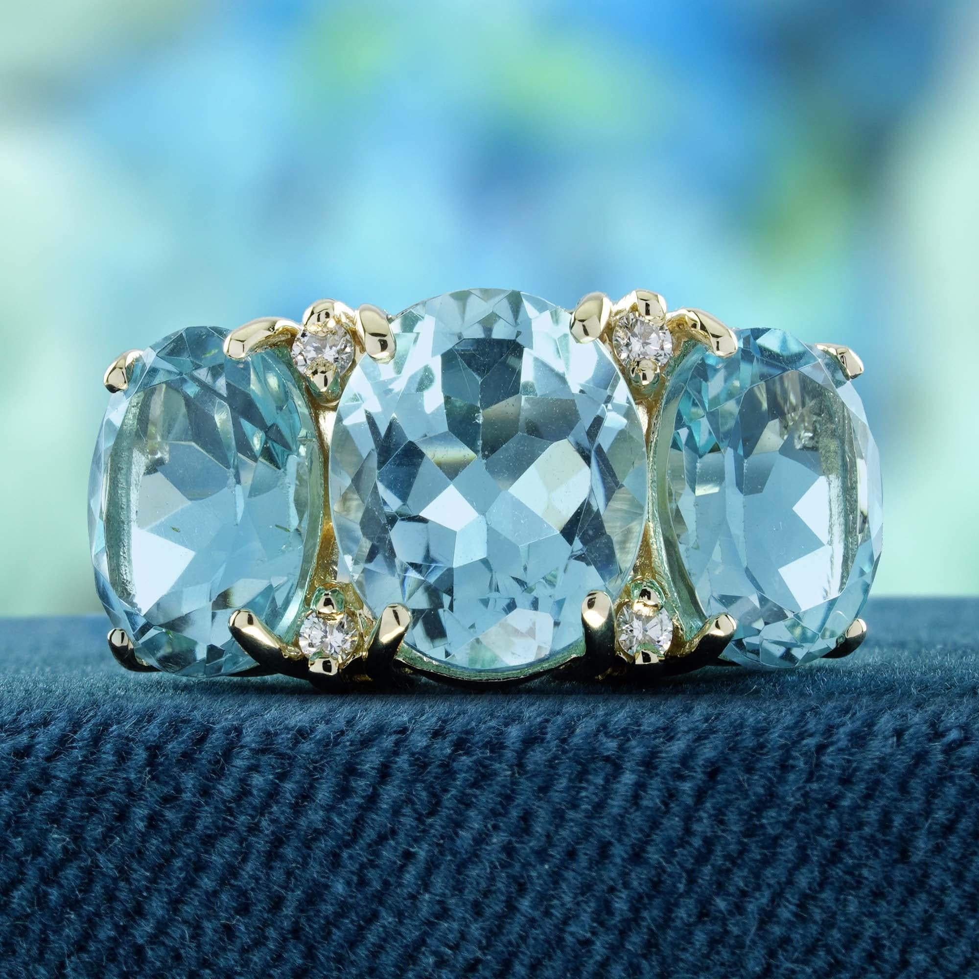 Elevate your style with this captivating vintage-inspired three-stone ring, expertly crafted in yellow gold. Featuring a central oval blue topaz flanked by two smaller topaz stones and also adorned with sparkling diamonds, which are set in a