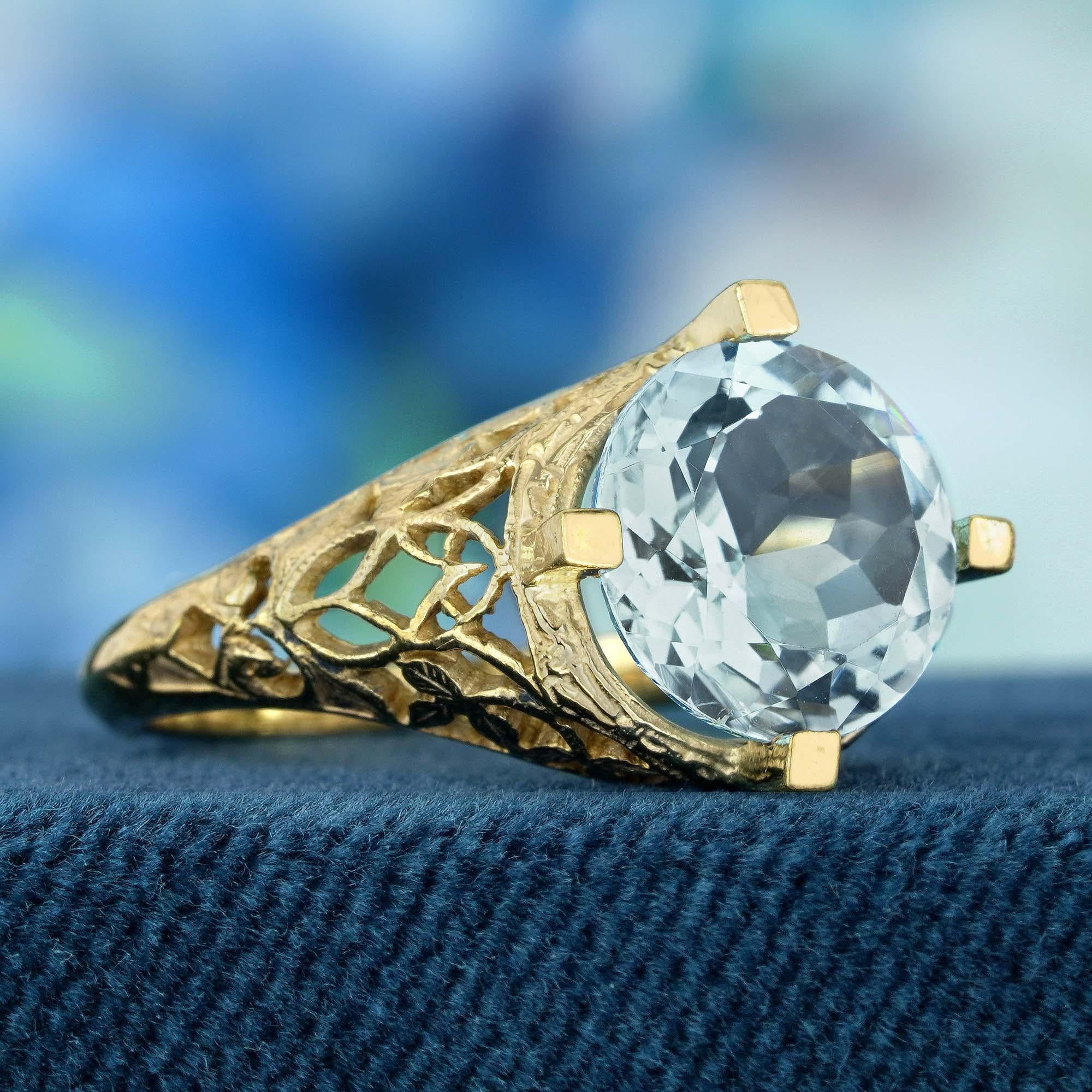 Capture the essence of the sky with our blue topaz vintage style filigree ring in yellow gold. Featuring a stunning round blue topaz stone in a serene sky blue hue, this ring radiates beauty and grace. Crafted with intricate filigree detailing, it