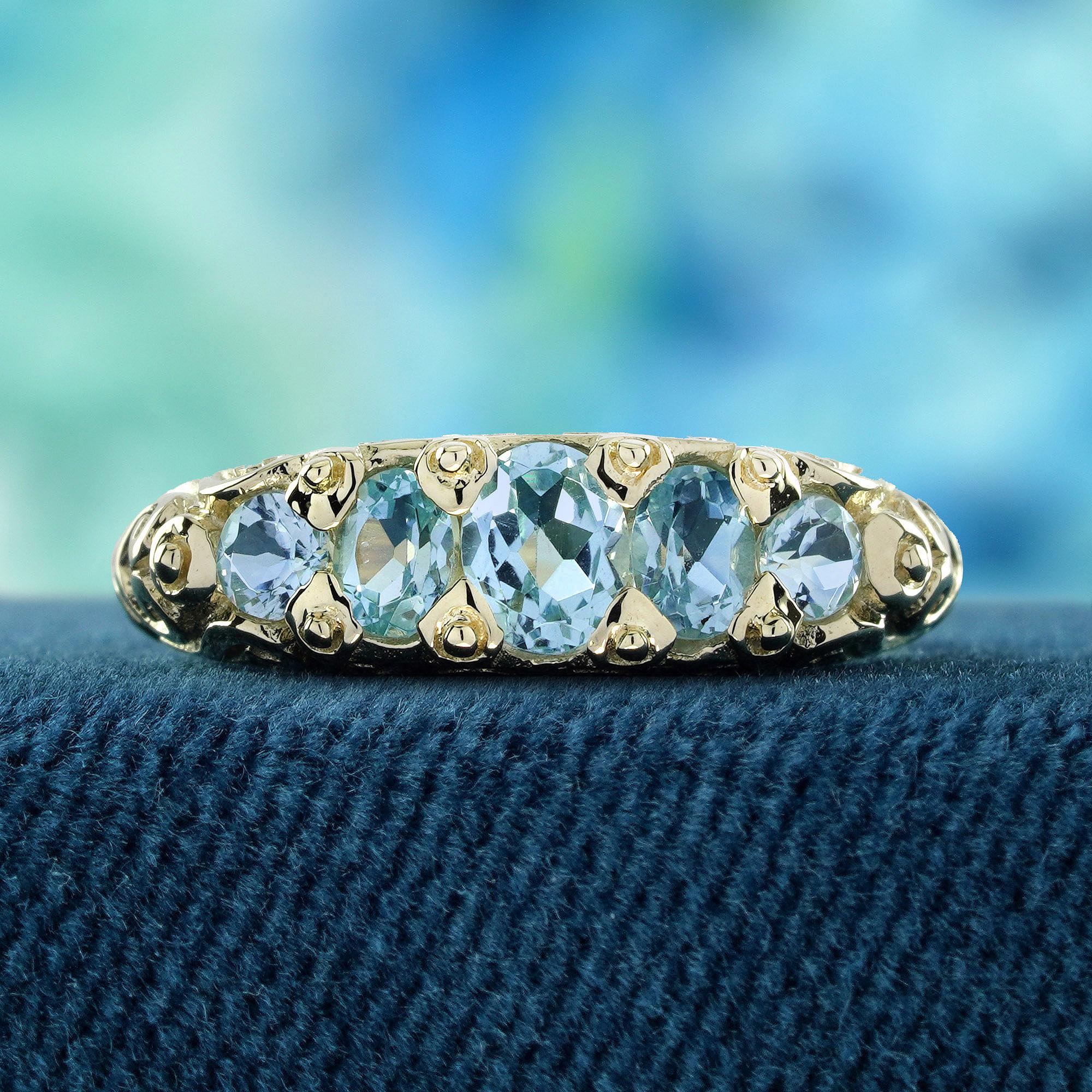 Discover timeless elegance with our blue topaz vintage style five stone ring in yellow gold. delicately cradled in a prong setting band. Each sky blue oval topaz stone is meticulously arranged to capture the essence of sophistication and grace.
