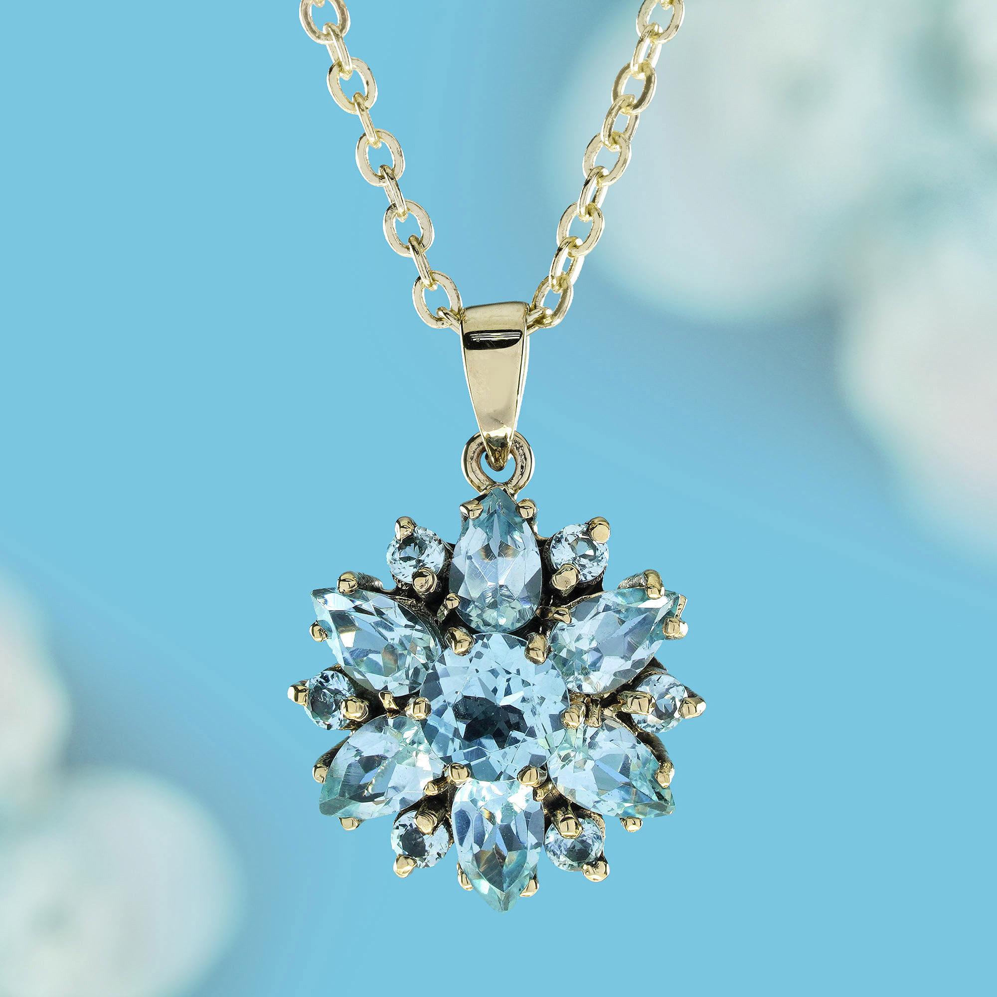 Crafted from solid yellow gold, this lovely floral cluster pendant is adorned with multi-shaped sky blue topaz. The double-layered flower boasts a central round blue topaz encircled by smaller round and pear shaped topazes, all securely set in