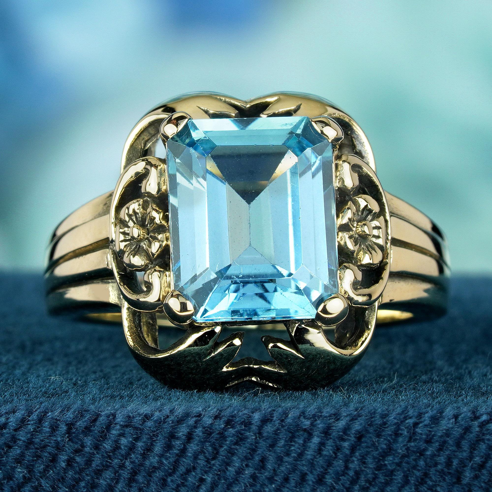 At its heart of this vintage-inspired ring lies a magnificent octagonal-cut natural blue topaz, exuding a captivating azure hue that evokes visions of clear skies on a sunny day. This stunning gemstone is a true marvel of nature, its brilliance