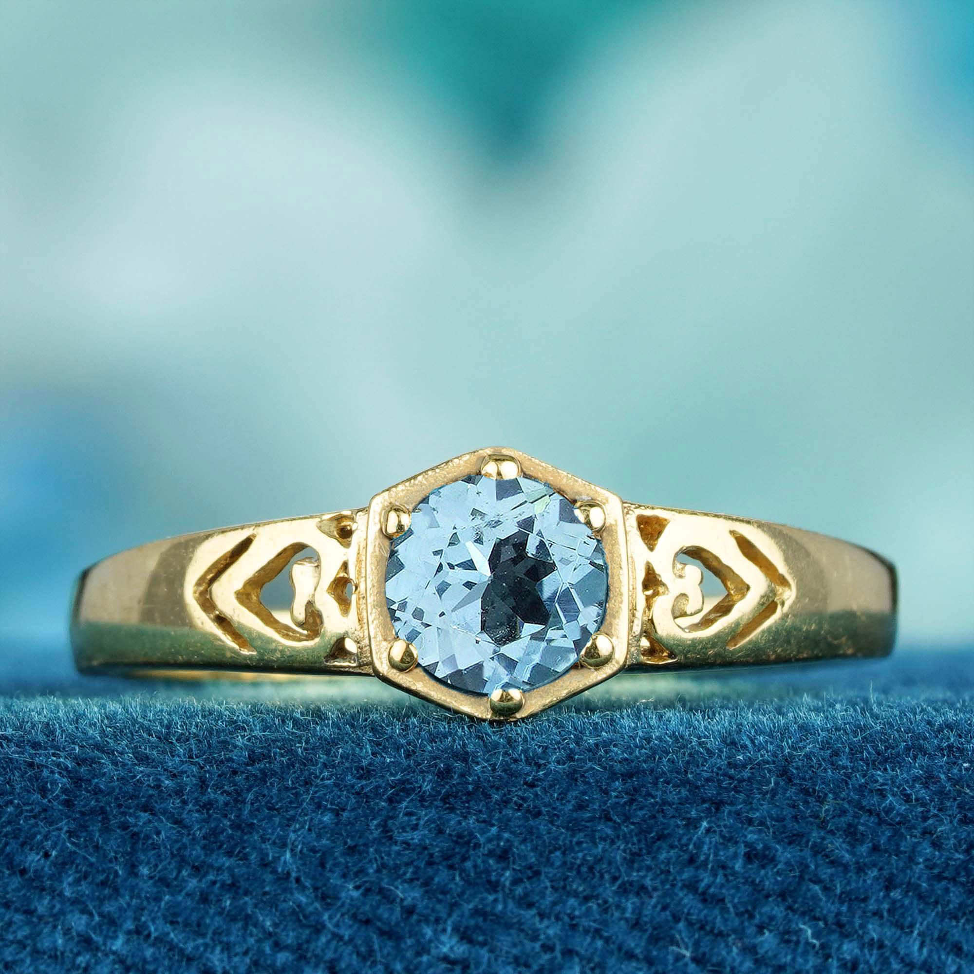 Elevate your love story with this stunning natural blue topaz vintage style engagement ring in solid yellow gold. Featuring a round blue topaz that symbolizes loyalty and trust, this exquisite solitaire ring is lovingly prong set to showcase the