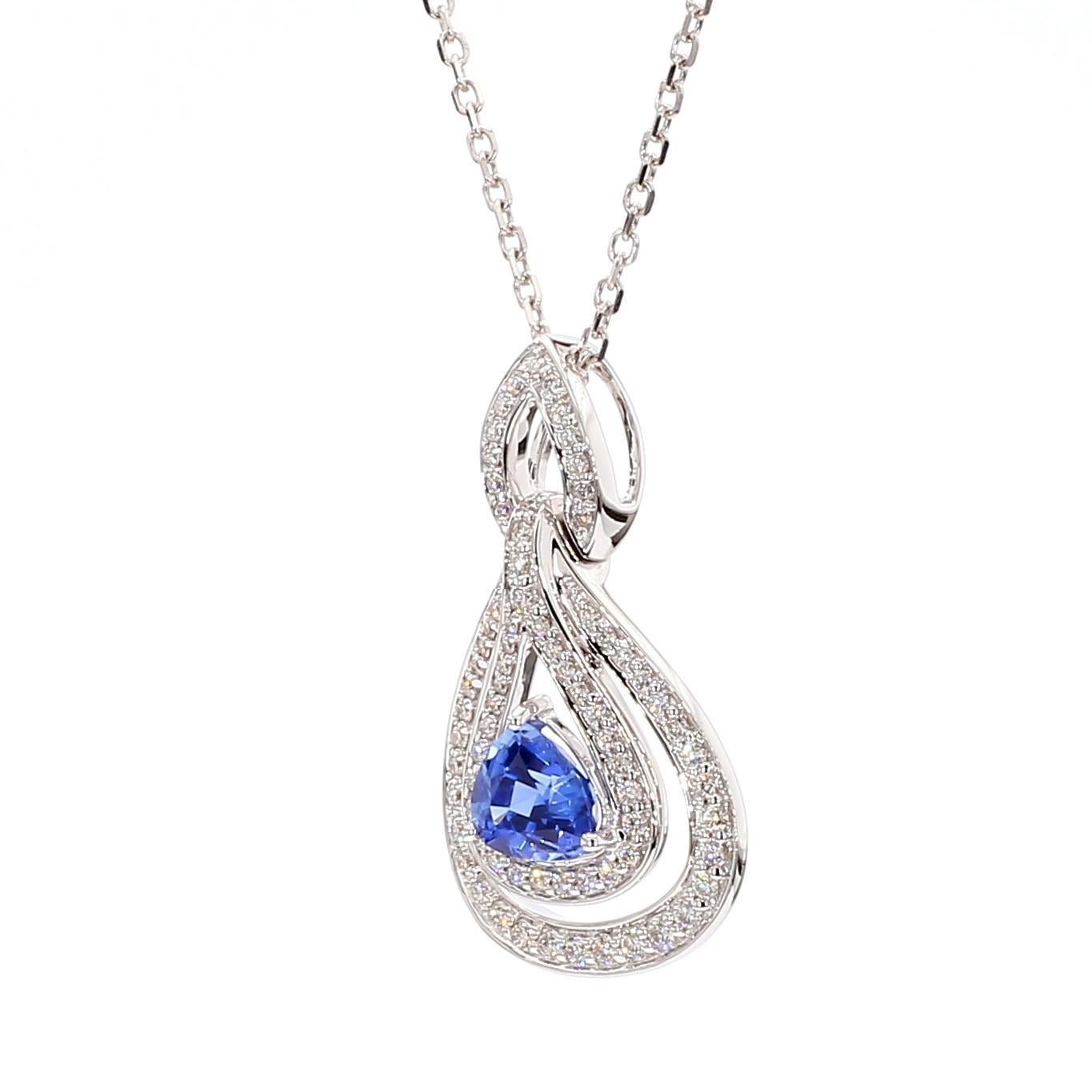 RareGemWorld's beautiful sapphire pendant. Mounted in a beautiful 18K White Gold setting with a natural trillion cut blue sapphire. The sapphire is surrounded by natural round white diamond melee. This pendant is guaranteed to impress and enhance