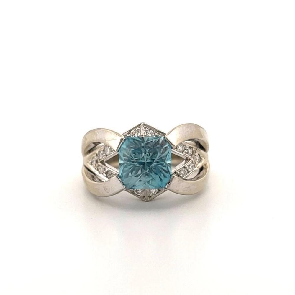 Custom Blue Zircon and Diamond Ladies' Ring 14K White Gold Square Euro Shank 3.35ct Center

Offered here is a bold and beautifully crafted ladies’ ring featuring a vibrant blue zircon and diamond design in solid 14K white gold. The centerpiece is a