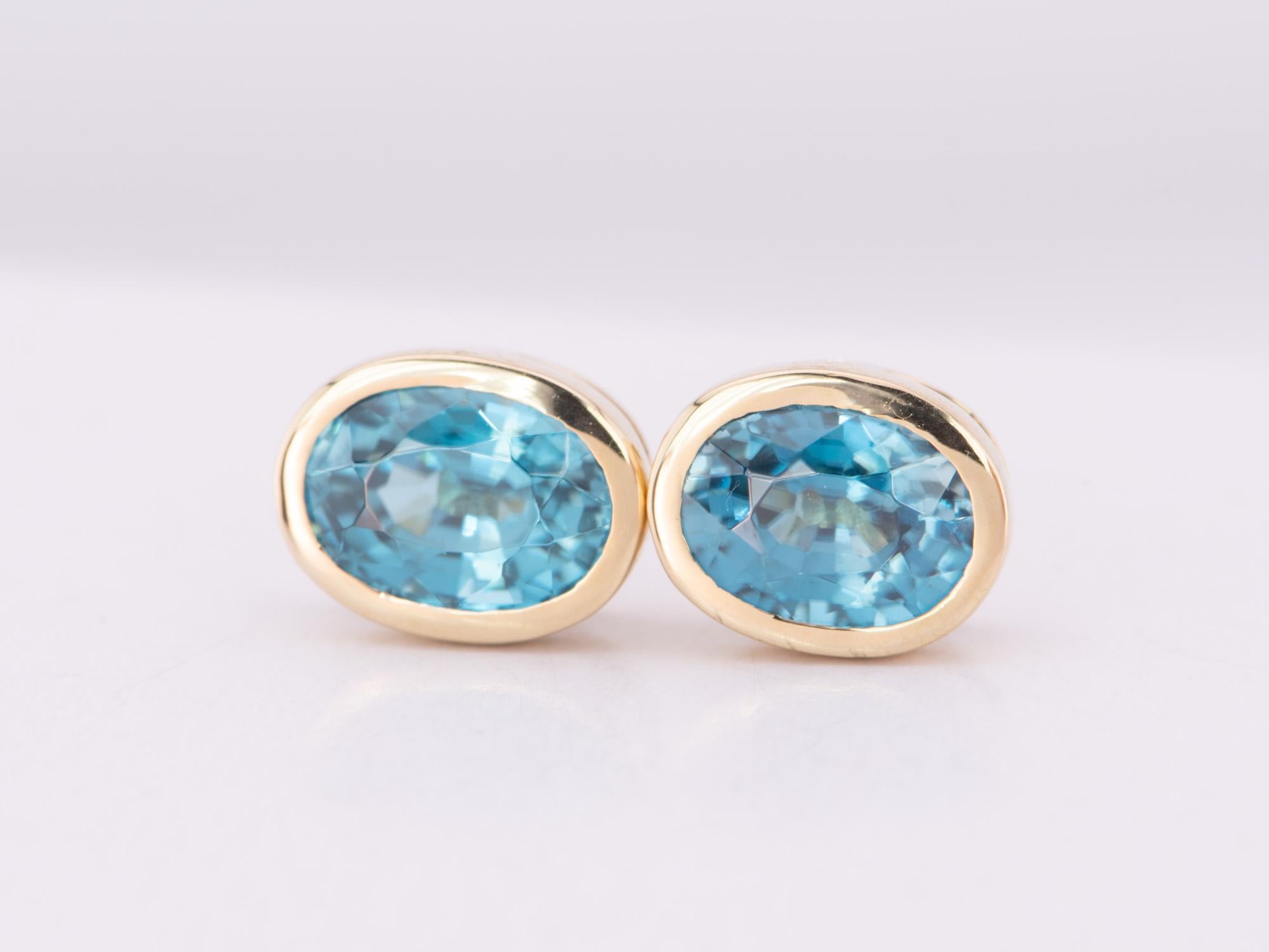 ♥ Natural Blue Zircon Bezel Set Ear Studs 14K Gold Rainbow Collection
♥ The item measures 8mm in length, 6.3mm in width, and 4.3mm in height.

♥ Material: 14K Gold
♥ Gemstone: Zircon, 2.92ct 
♥ All stone(s) used are genuine, earth-mined, and