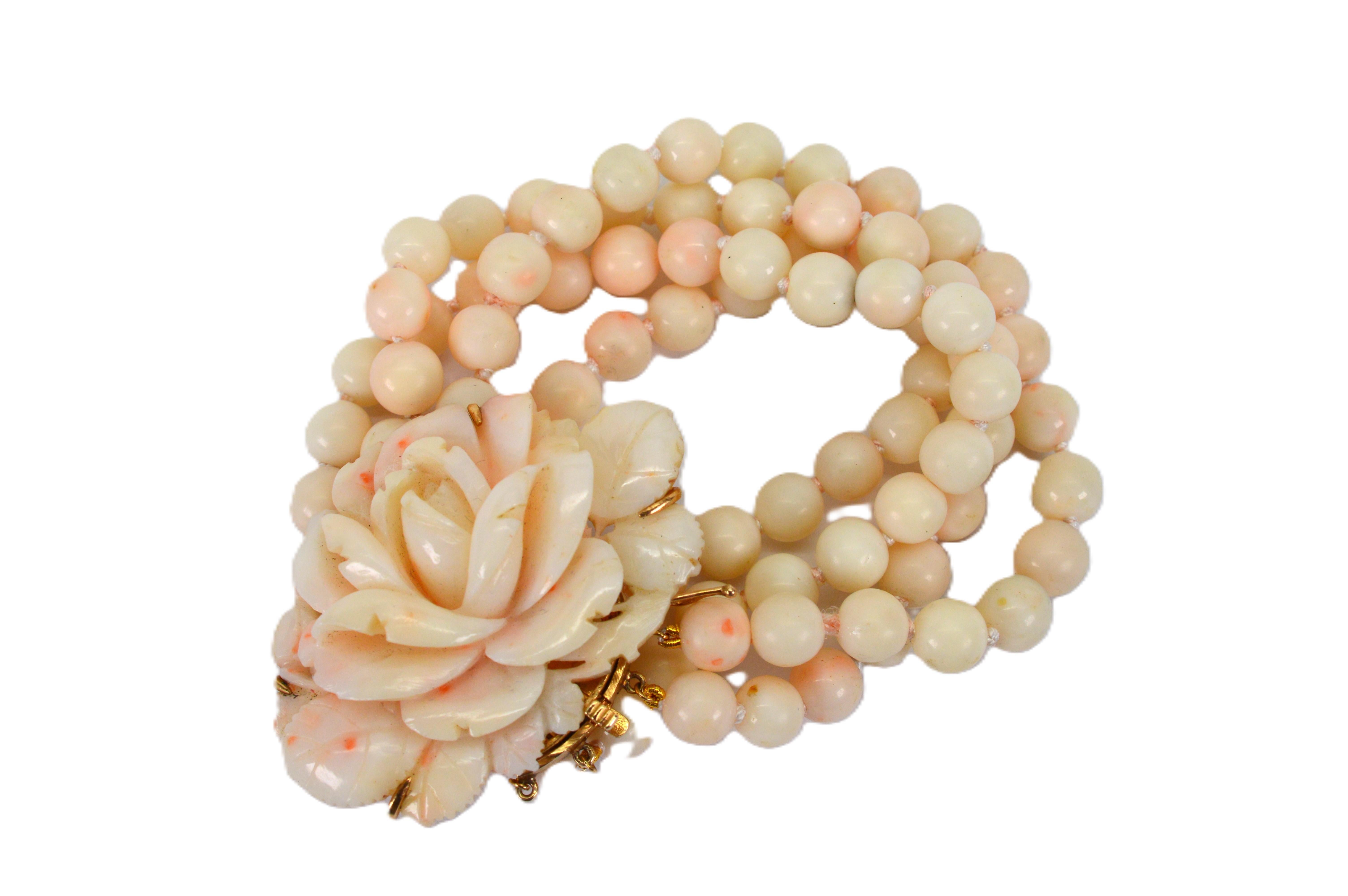 Meticulously hand carved in blush-toned natural coral, this wonderfully romantic heirloom beaded bracelet with its beautifully carved coral floral bloom ornamental clasp presents true mid-century elegance. Four beaded strands including one hundred