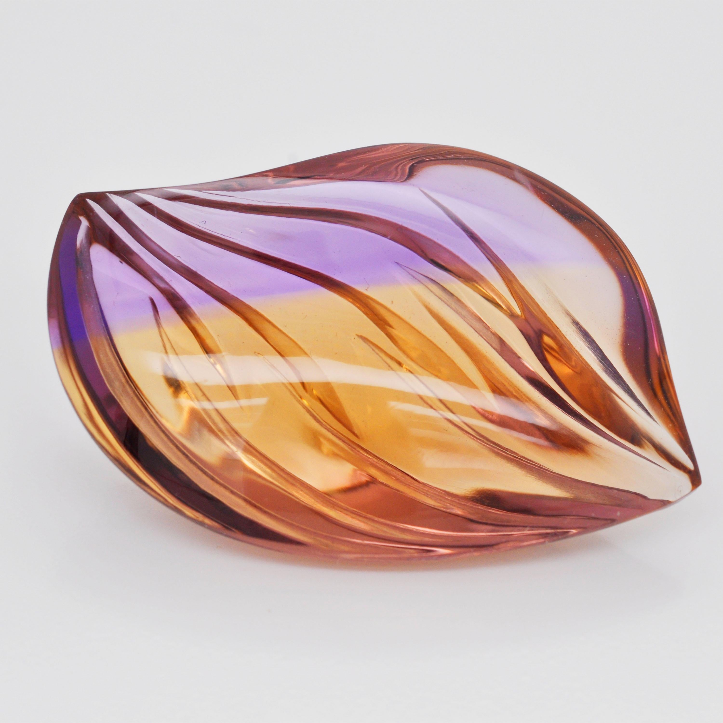 Natural bolivian ametrine hand carved fancy cut loose gemstone pendant brooch.

Introducing our exquisite natural Bolivian ametrine fancy Mango shaped hand carved gemstone. This unique gem features a stunning fusion of amethyst and citrine hues in a