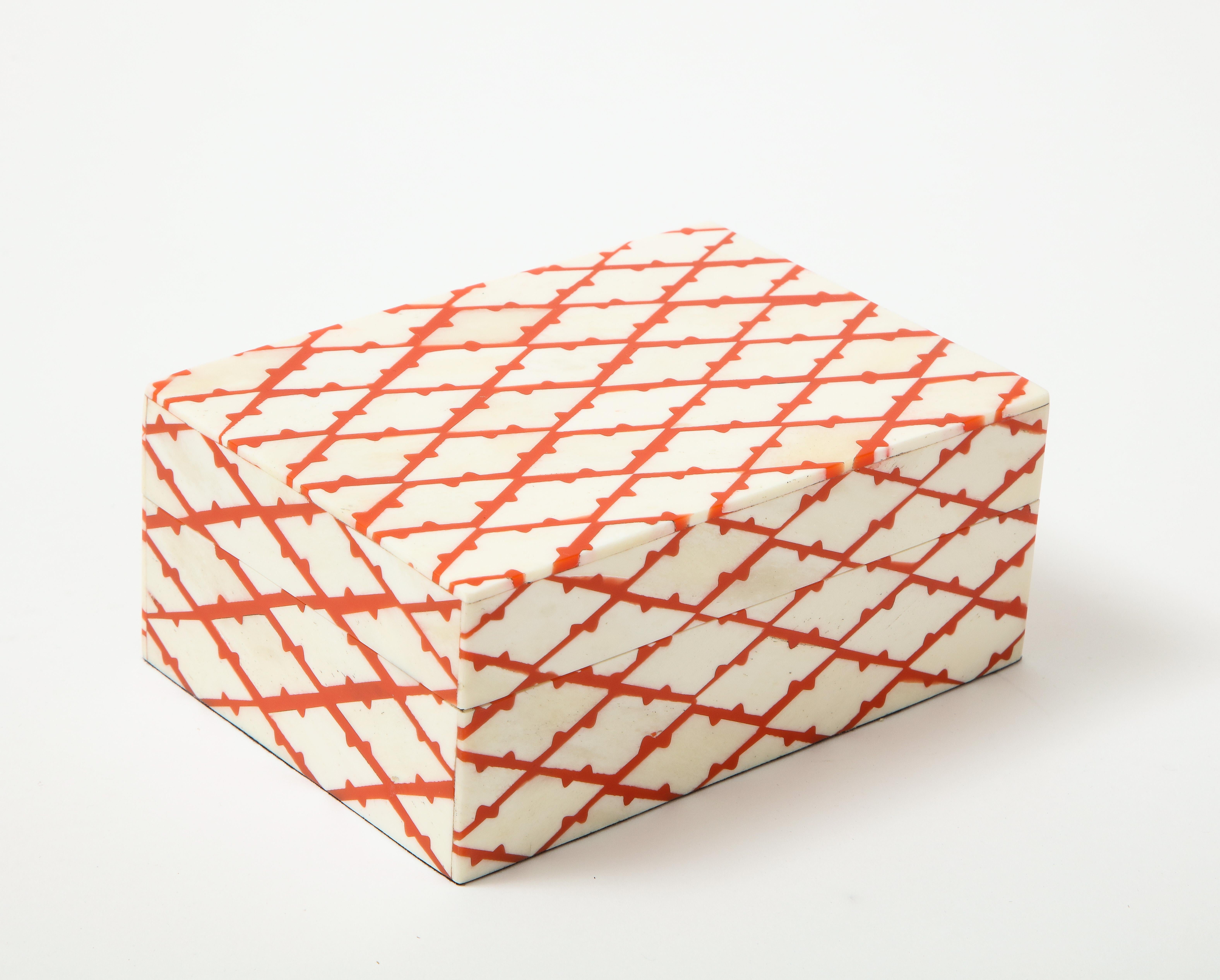 Modernist keepsake box featuring natural bone with coral colored resin inlay in a trellis pattern. A great addition to any desk or bookcase. Measure: 5x7.