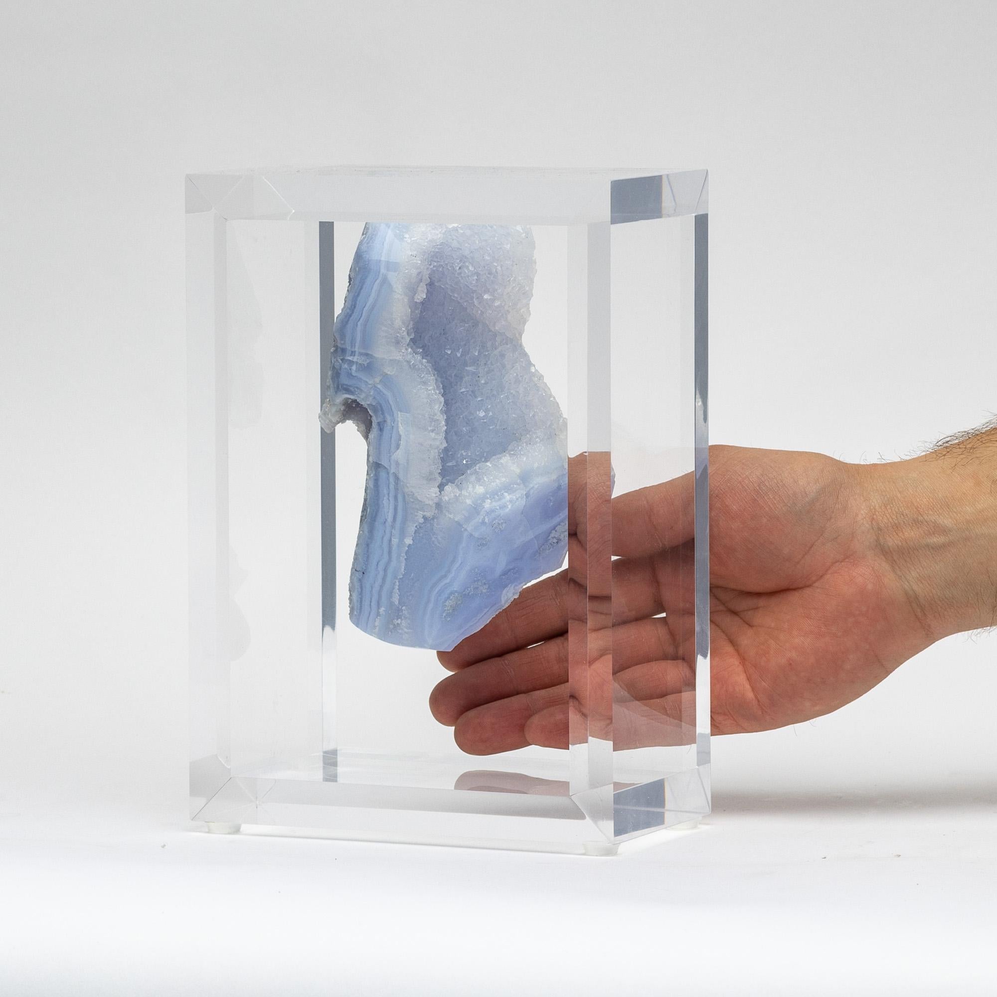 A unique specimen of free form blue agate from Brazil. With impressive reflective luster and natural growth lines.  Mounted in an original acrylic case design. 

