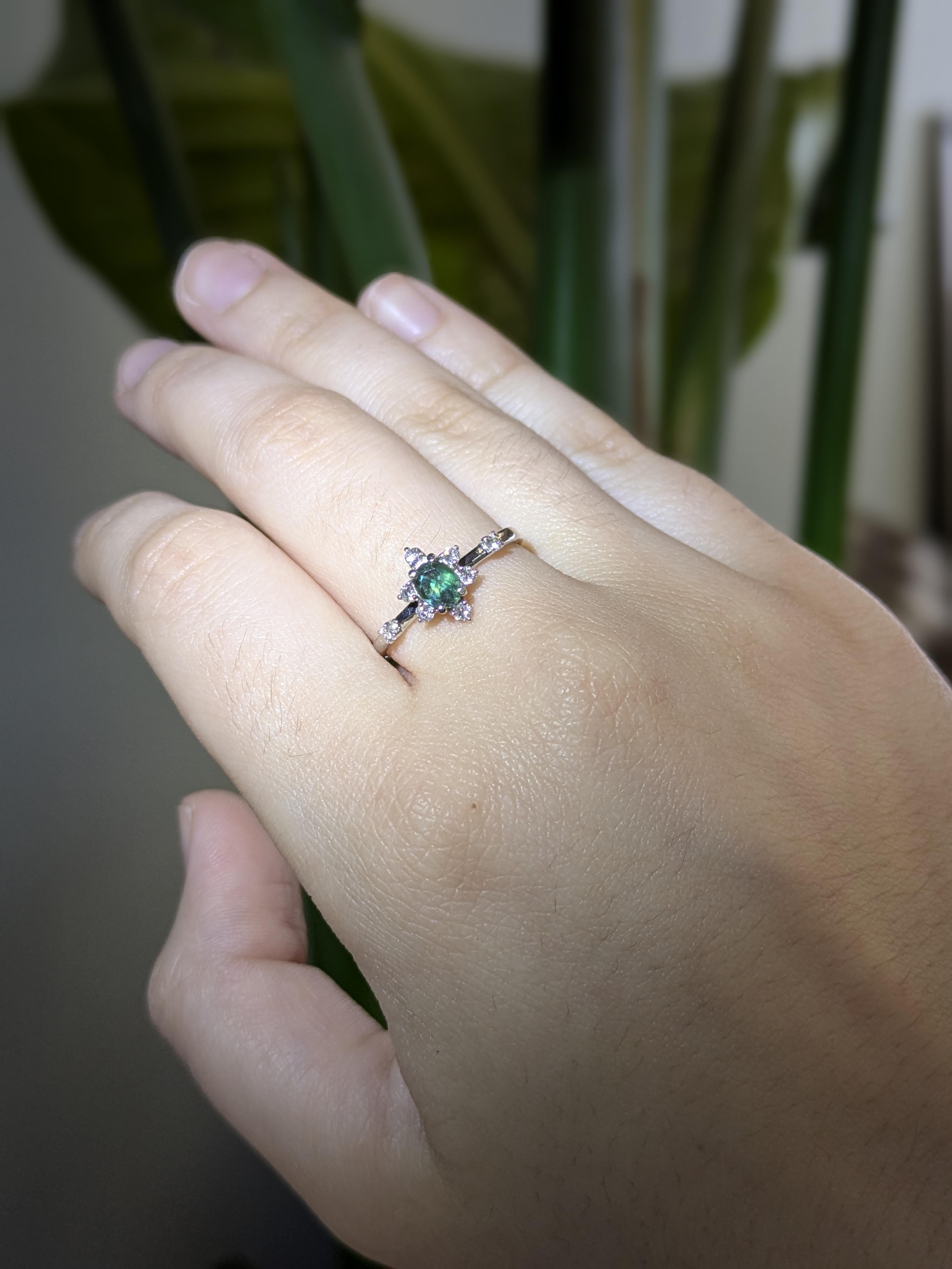 A true conversation piece, this exquisite ring showcases a 5x4mm oval Alexandrite, known for its enchanting color transformation. Set in solid 14k white gold with natural diamond accents, it’s a romantic and refined choice to mark life’s most