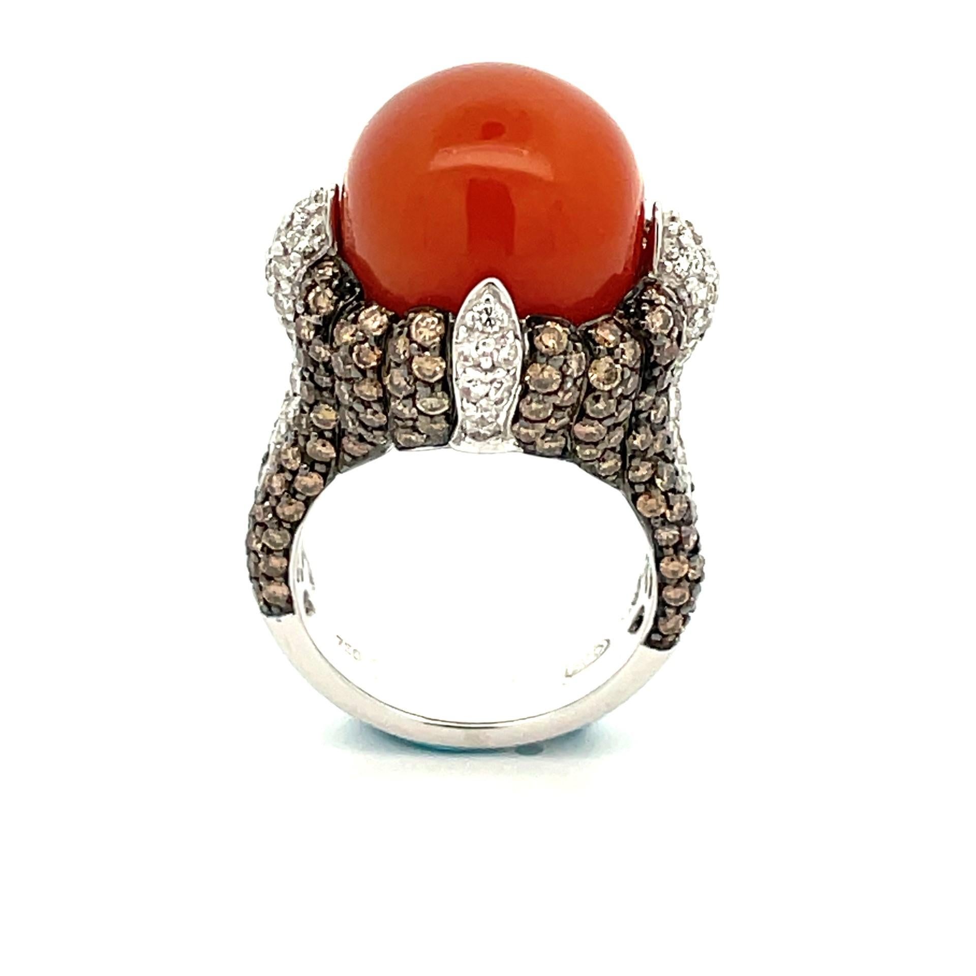 An impressive 18 karat white gold orange moonstone ring with natural white diamonds and black rhodium finish around natural brown diamonds , with a beautiful orange moonstons in the centre.

54 brilliant cut natural white diamonds .70ct total