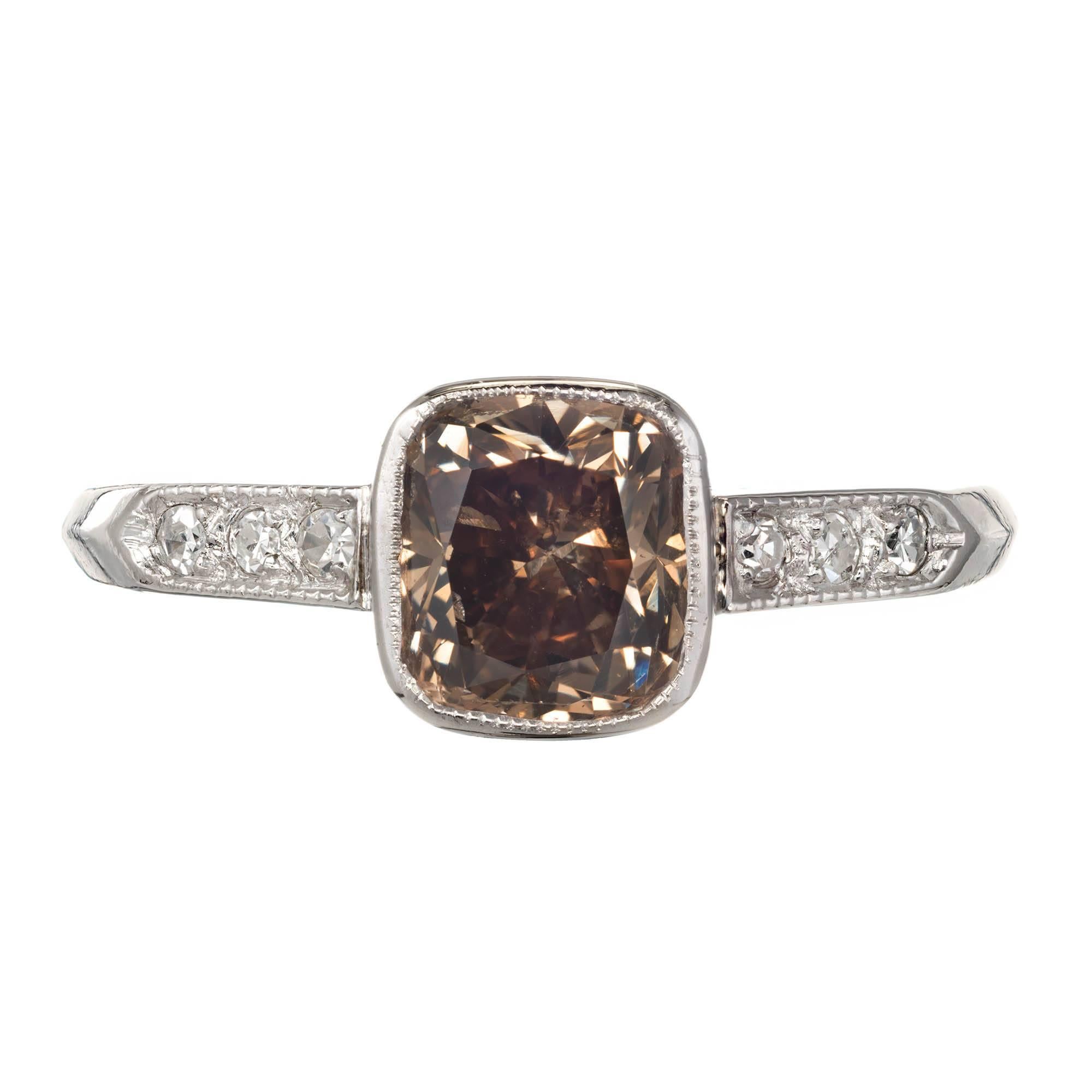 GIA certified natural color fancy brown diamond engagement ring. Antique cushion shape in an original 1930s Art Deco Platinum setting with 6 accent diamonds. GIA certificate #514157575564.

1 Antique cushion cut natural fancy color yellow brown