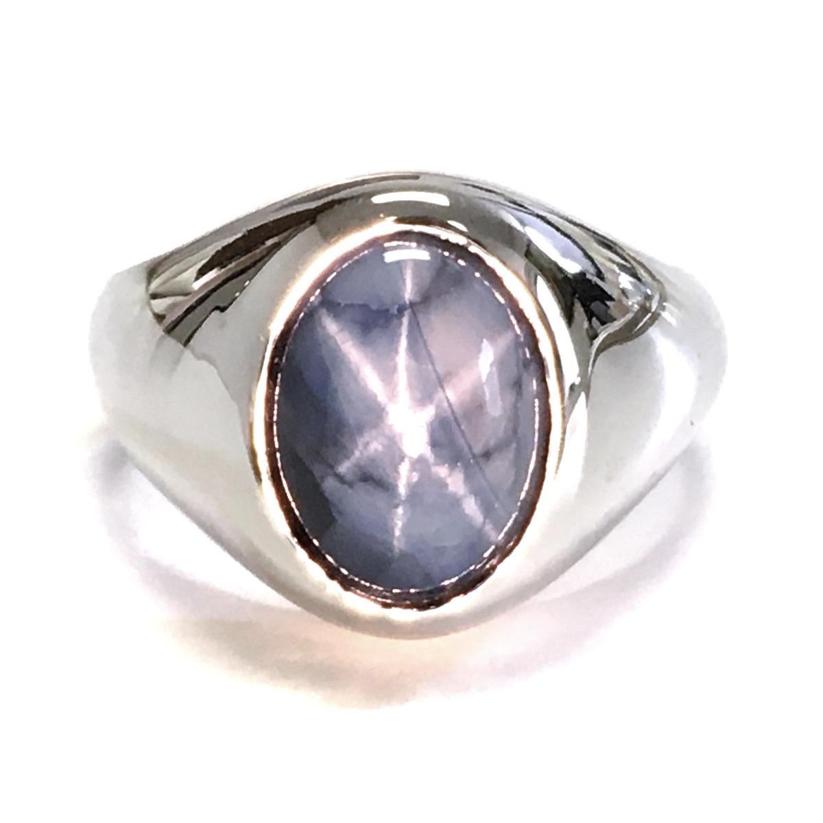 This white gold men's ring is a true statement piece, featuring a remarkable 9.00-carat Star Sapphire. The vivid blue hue of the sapphire creates a mesmerizing, hypnotic effect, and the gem displays a sharp and distinct star pattern with six rays