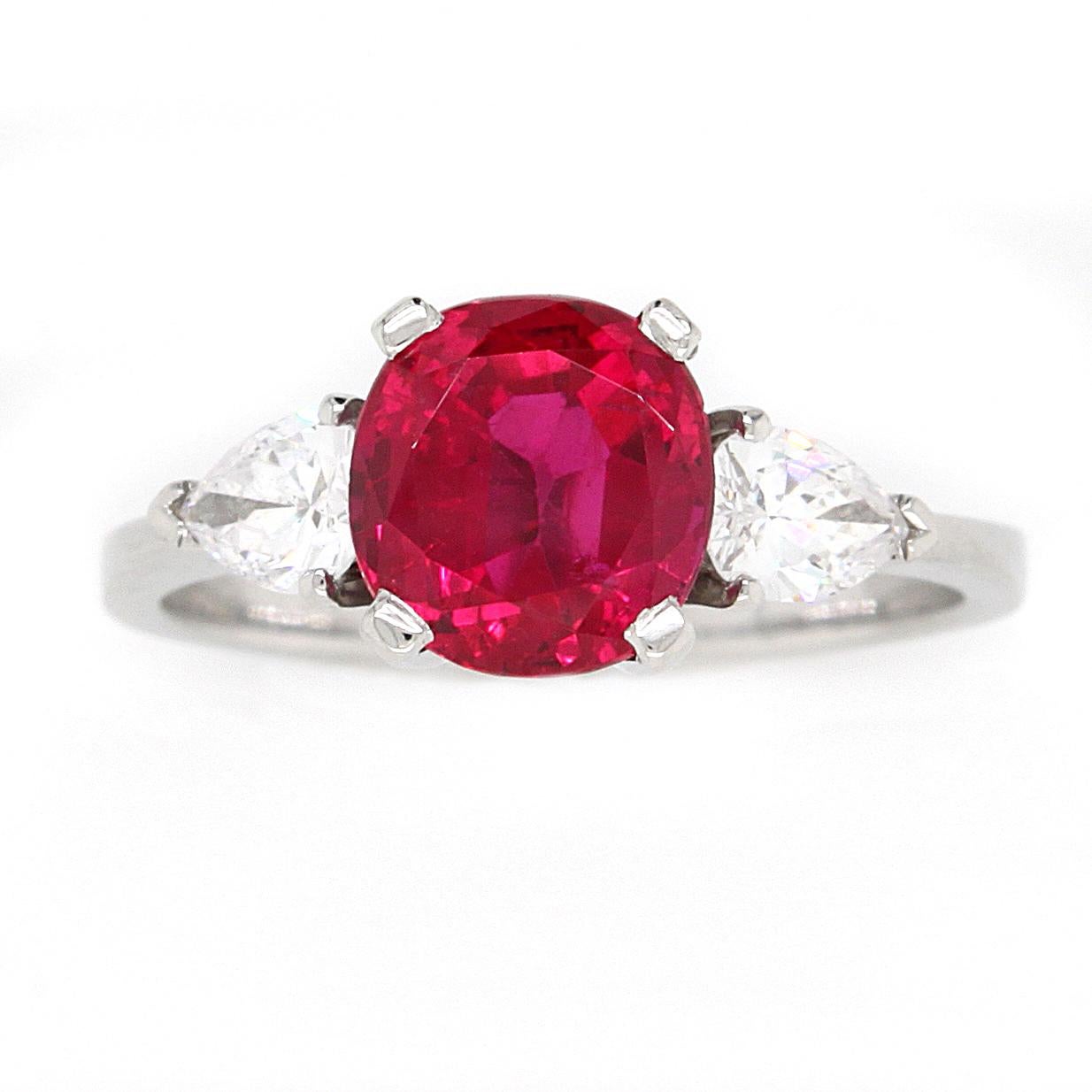 Natural Burmese ruby and diamond ring made by the famous Swiss jewellery house Gübelin.
Set in platinum with an antique cushion-shaped ruby weighing ca. 2.4ct, between two bright and lively pear-shaped diamond shoulders.
The ruby has a natural